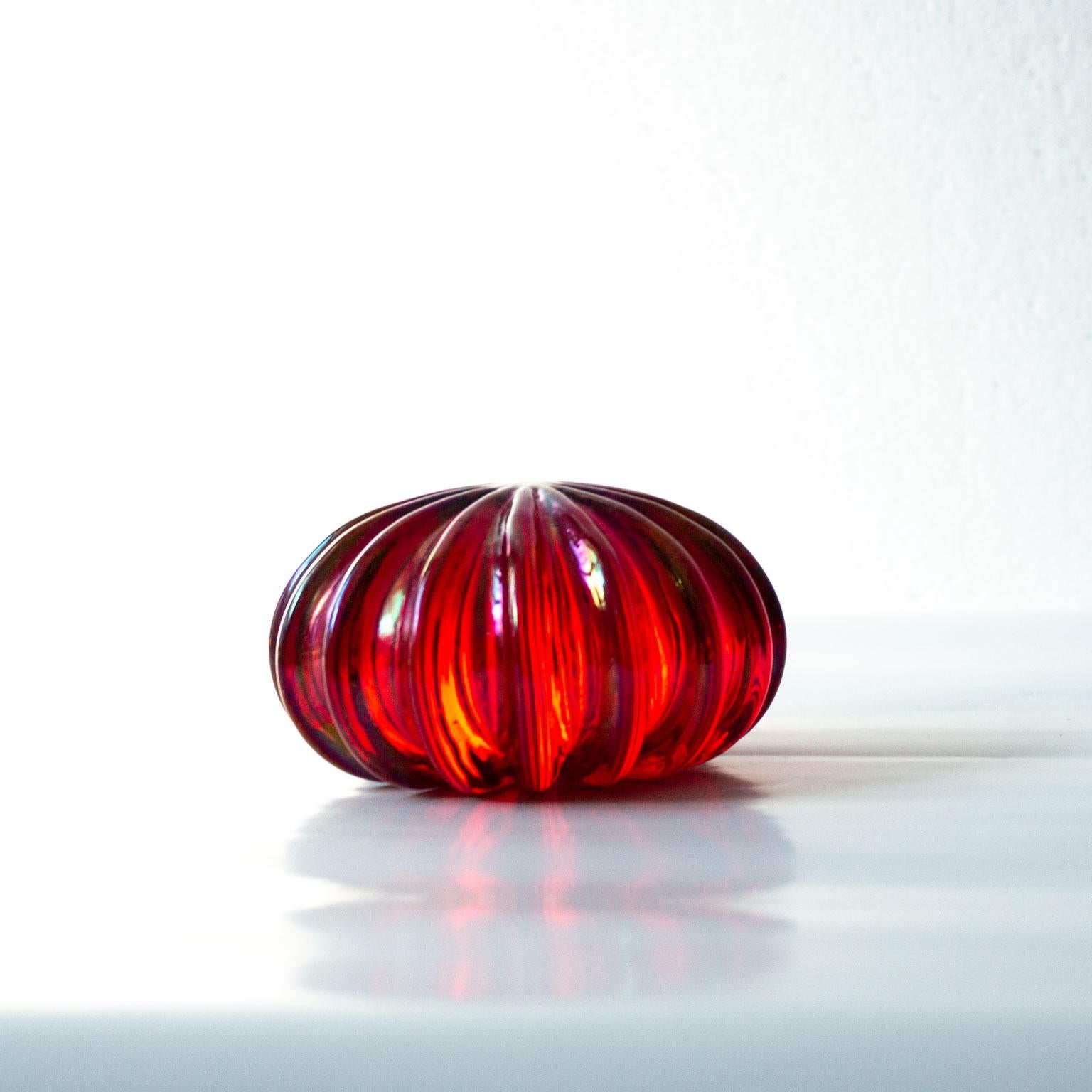 Signed Archimede Seguso Glass Paperweigh. Made in Murano, Italy. Ruby red glass with iridescent inclusions, circa 1970s. Signed A. Seguso. Murano. A poetic candy jewel that makes you happy every time you look at it.