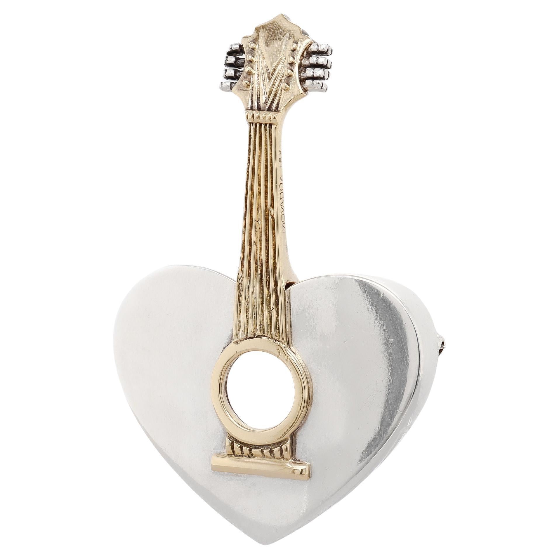 Spilla con mandolino a forma di cuore firmata Arman for Movado in argento sterling e oro 18 carati