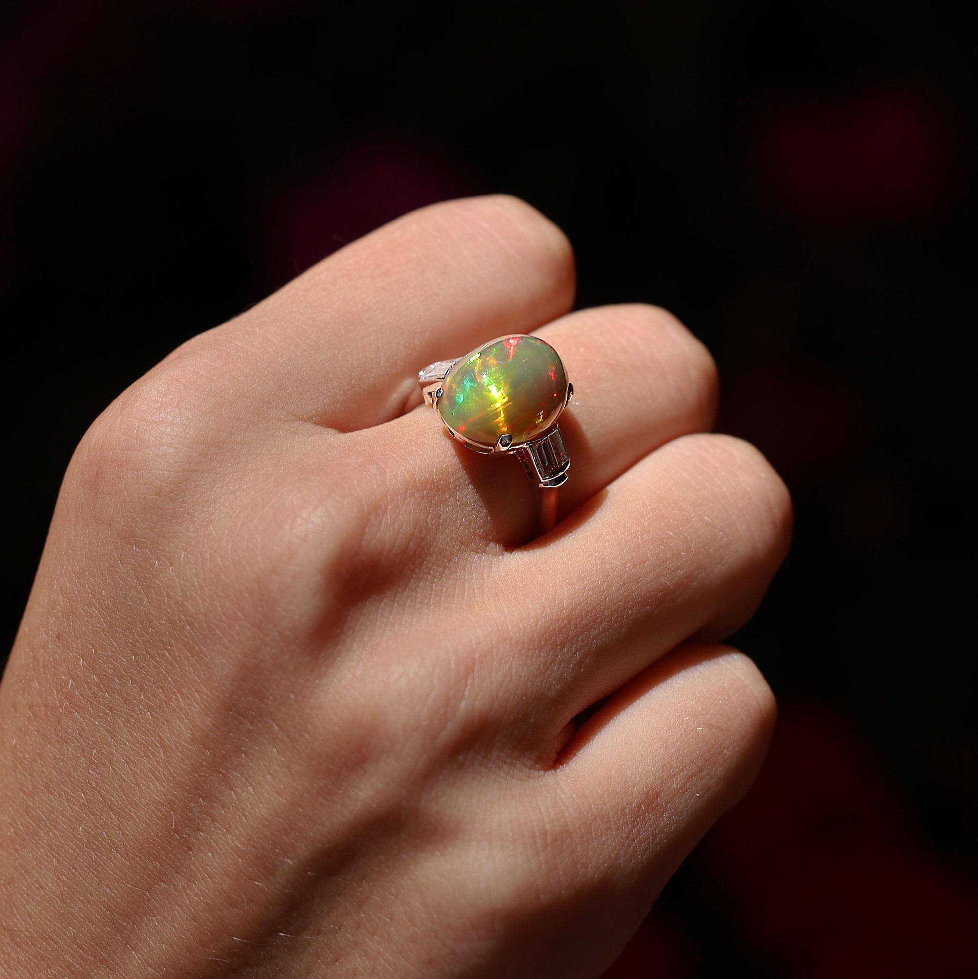 Recently acquired from the private estate of a gemstone collector, this sustainable Art Deco opal cocktail ring is signed with makers marks from legacy jeweler, Traub. Featuring a stunning 5 carat, high domed cabochon Australian opal, bold and