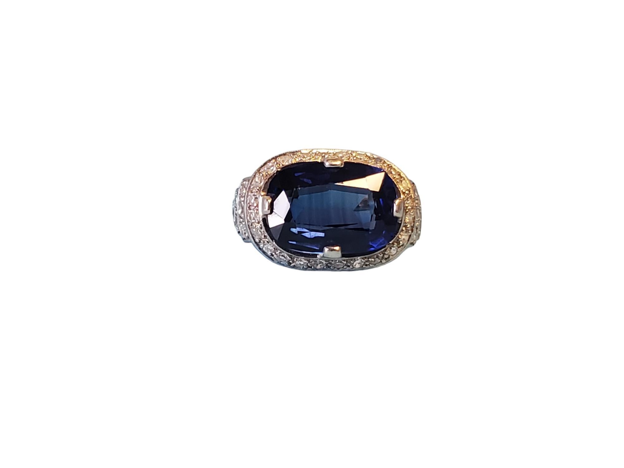 Listed is a gorgeous art deco plat and diamond mount with a pretty oval blue sapphire. The ring is hand crafted and features white single cut diamond around the center stone and on the shank for an approximately .36tcw.  Size 6.75, this ring is in