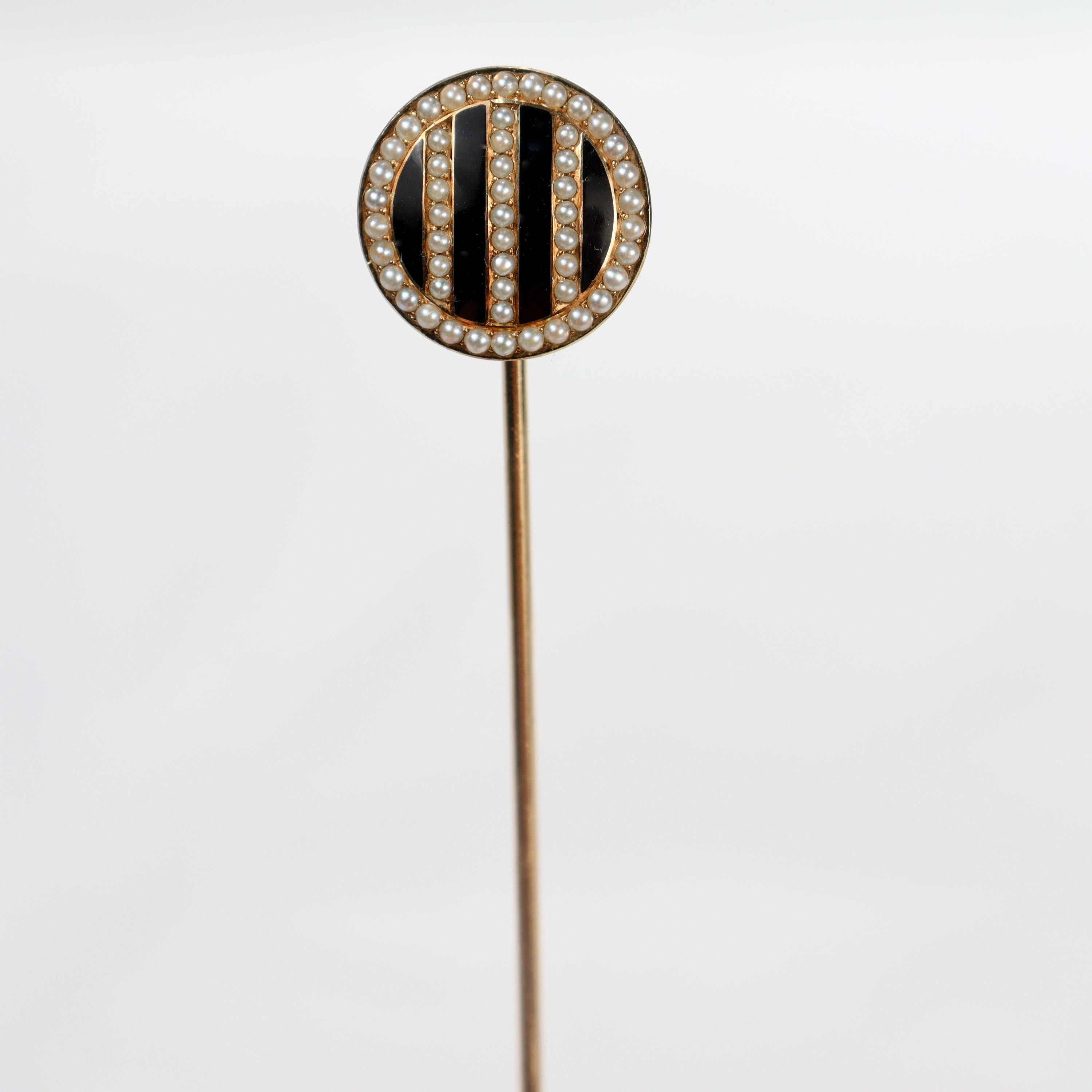A very fine signed Art Deco hat pin.

By Riker Bros.

In 14k yellow gold. 

With alternating stripes of black enamel and channel set seed pearls. 

The reverse is hinged to very long pin stem.

Simply a wonderfully handsome Art Deco hat