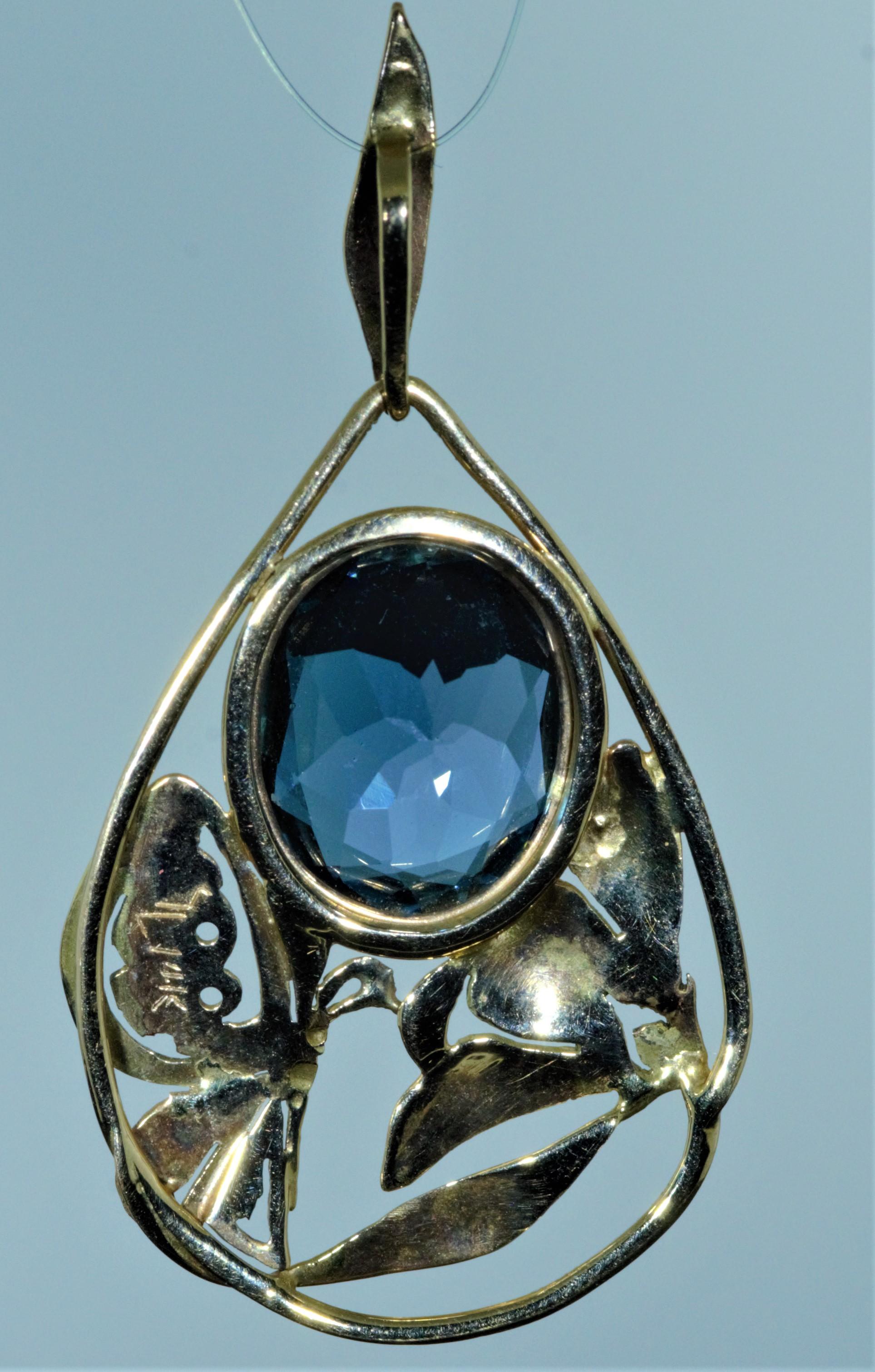 Ladies Handmade 14 Karat Yellow Gold Arts and Crafts Period Blue Topaz Pendant featuring a butterfly sipping nectar from a flower! Measures over 1.5 inches in length and 7/8 inch wide.  

There is a signature on the piece however we do not recognize