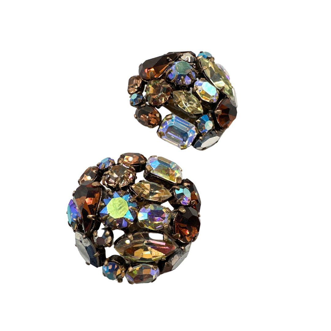 Earrings Diameter: 1.25″
Bin Code M20 / P15
Indulge in the timeless charm of vintage fashion with these exquisite Austria Signed Multi-Color Cut Glass Rhinestone Vintage Earrings. Crafted with meticulous attention to detail, these earrings exude
