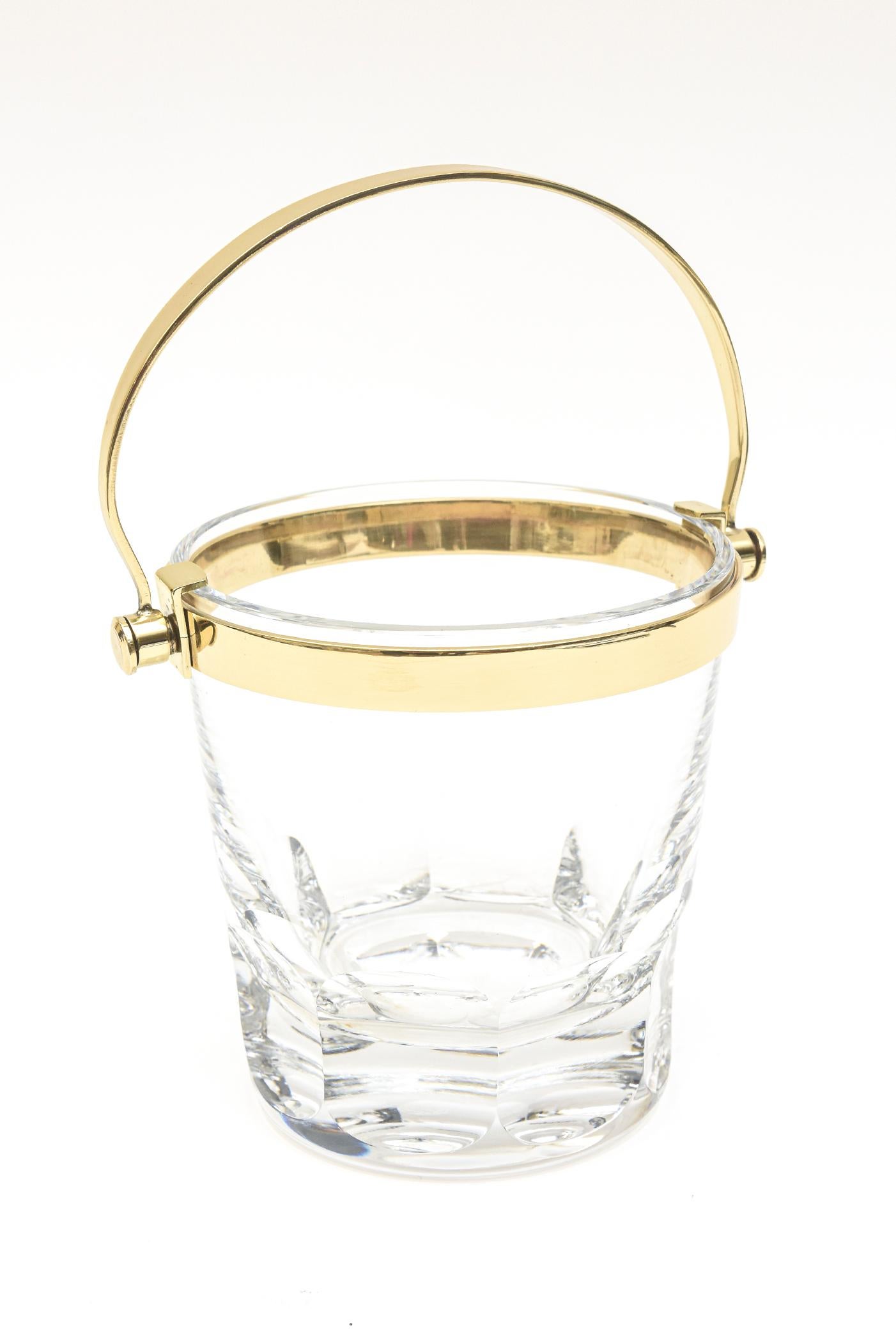 This lovely timeless hallmarked vintage Baccarat crystal and brass small ice bucket is modernist. It is from the 1960s. The cut block crystal at the bottom adds dimension. All of the brass armature has been polished and cleaned. To the top of the