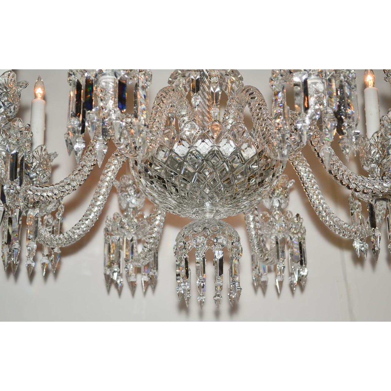 Exquisite signed Baccarat cut crystal chandelier of paragon quality. The scalloped and vase-shaped crown atop curved projections with flower-cup dangles and icicle prisms. The diamond patterned contoured stem mounted with eight gracefully scrolled