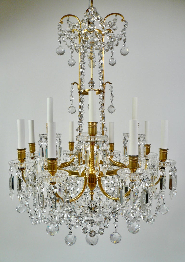 This truly fantastic chandelier is of the finest quality and of beautiful proportion!
It is signed Baccarat on all twelve crystal bobeches and on the bronze frame.