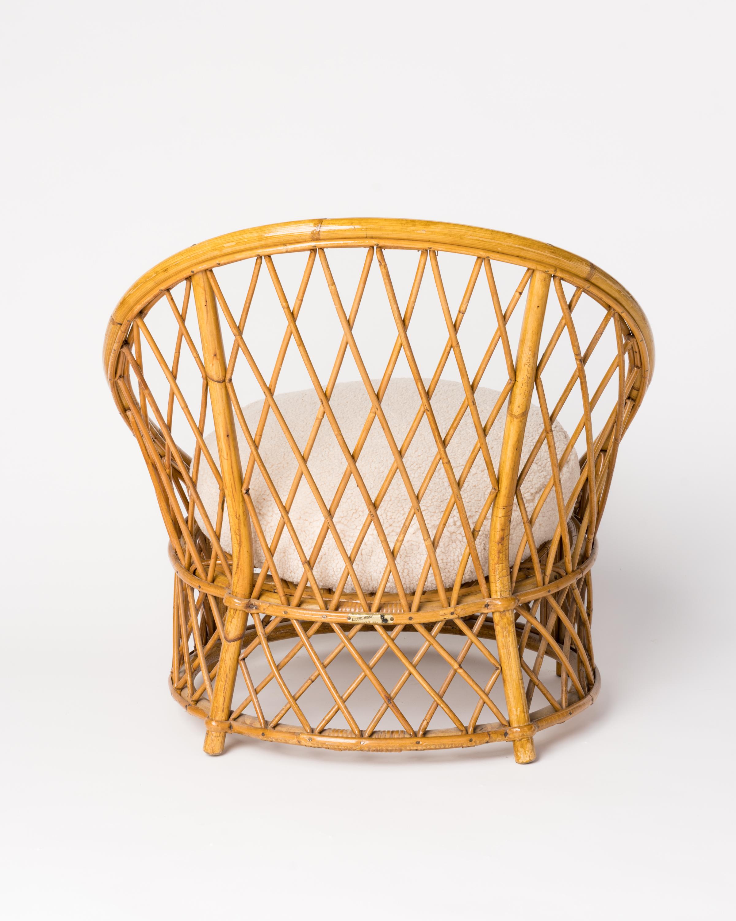 Mid-20th Century Signed Bergère Rattan Chair by Audoux Minnet w. Cream Bouclé Cushions, France