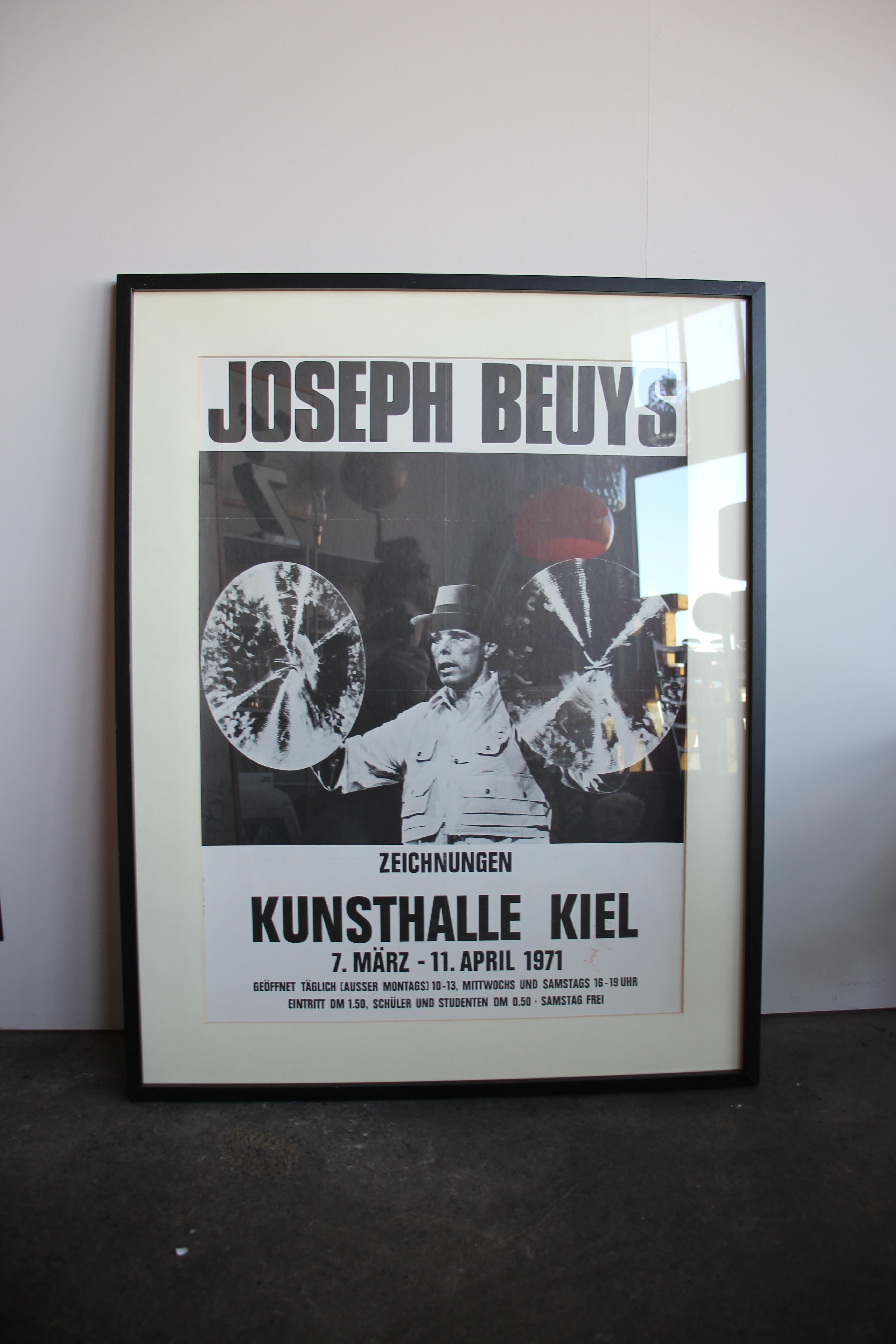 Signed black and white exhibition poster of Joseph Beuys' exhibition in Kiel in 1971. It is signed by the artist with a red pen. The piece is in a black wooden frame, also made in circa 1971.

 