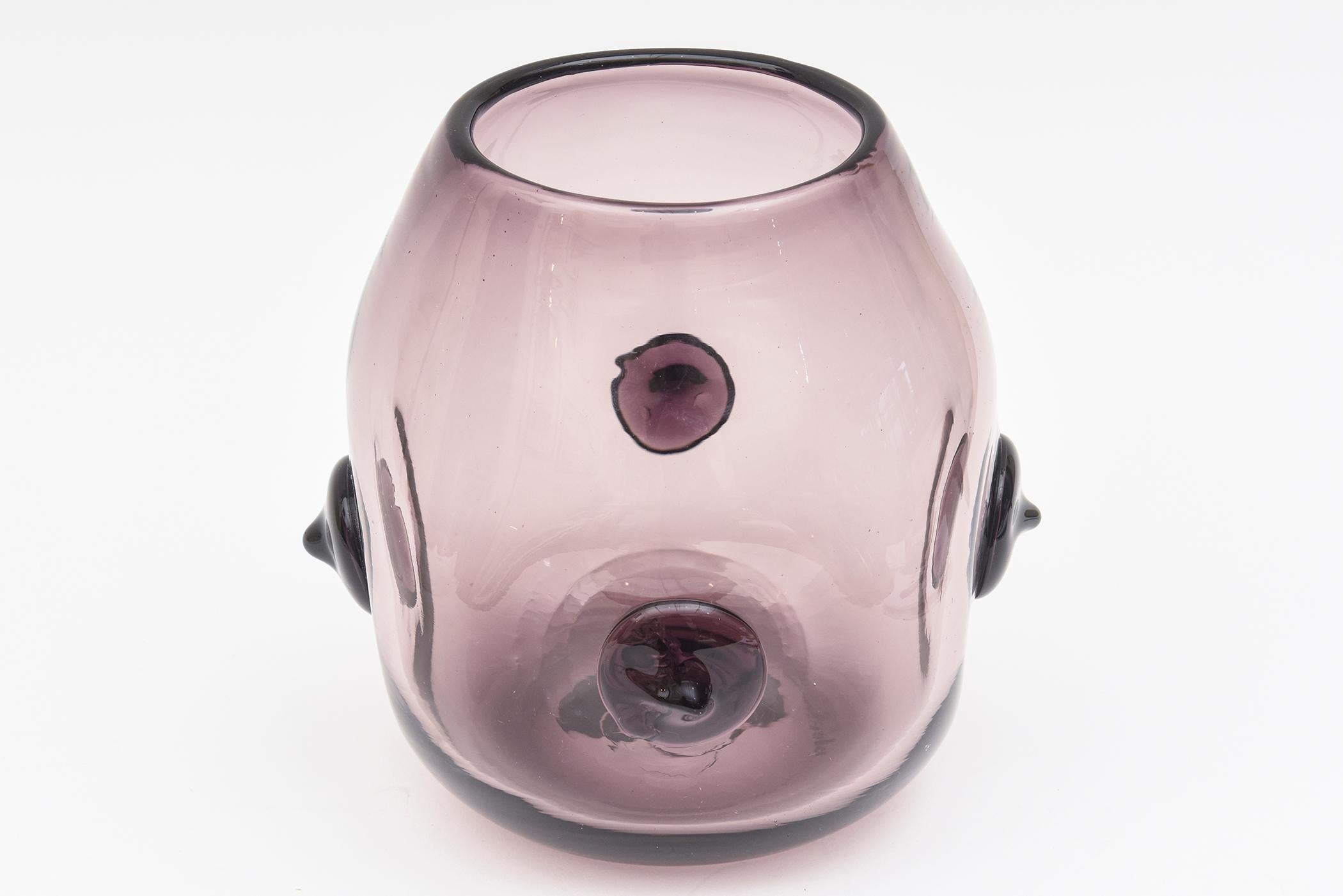 This rare and obscure signed Blenko vase or vessel is a luscious color of light purple. It was designed by Wayne Husted for Blenko and was most likely an experimental piece which makes it even more rare. It has 4 nipple like protrusions surround. It