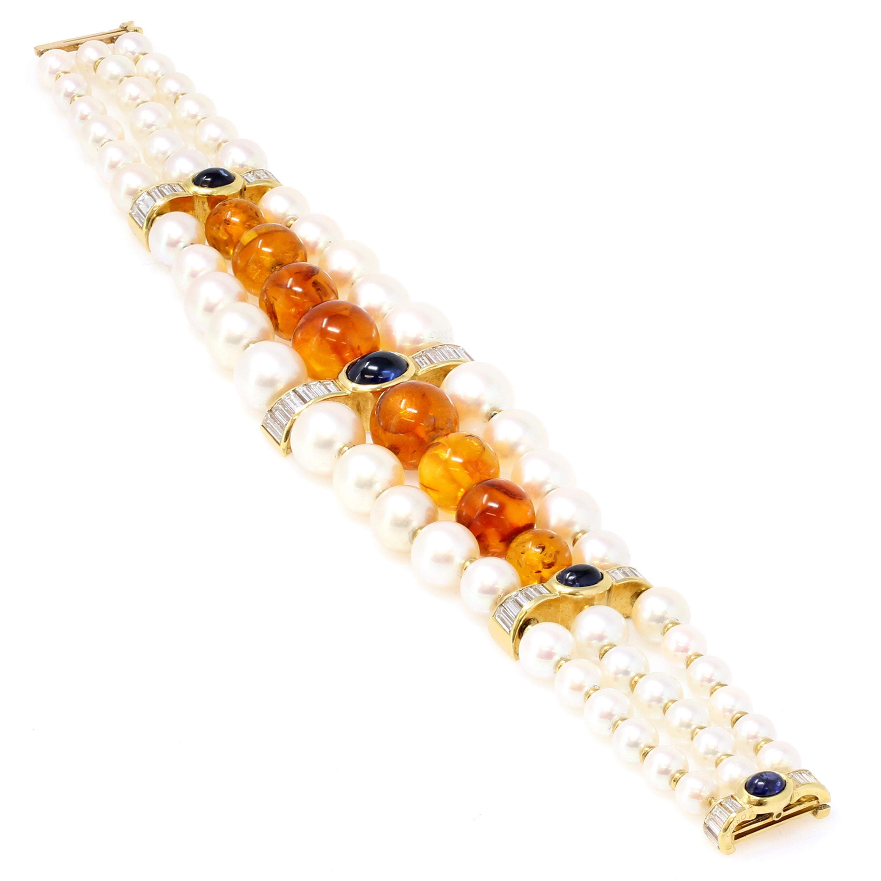 A French signed Boucheron Akoya pearl, amber, sapphire and diamond bracelet from the 1980s, in 18K yellow gold. One of its kind and of high end quality, this signed Boucheron bracelet showcases a row of amber beads ranging from 8 to 11 mm,