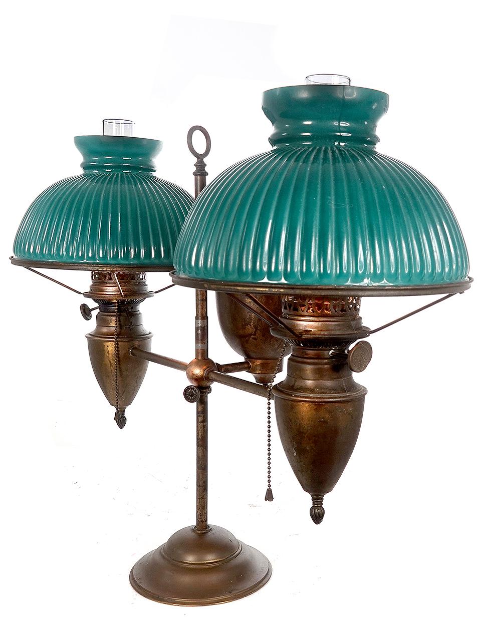This is a beautiful newly wired Bradley and Hubbard double oil student's desk lamp. It moves up and down on the center stand and rod. The shade is a unique green over ribbed white sandwich glass. As with all B and H lamps it is well made and has