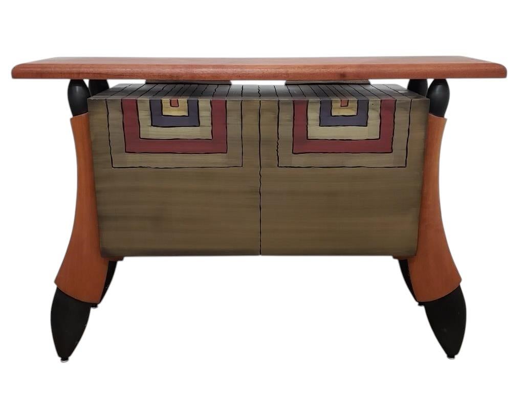Add a touch of refined artistry and timeless craftsmanship to your home with this Signed Brent Skidmore Console Cabinet. Known for his ability to blend modern design with traditional woodworking techniques, Skidmore has created a stunning piece that