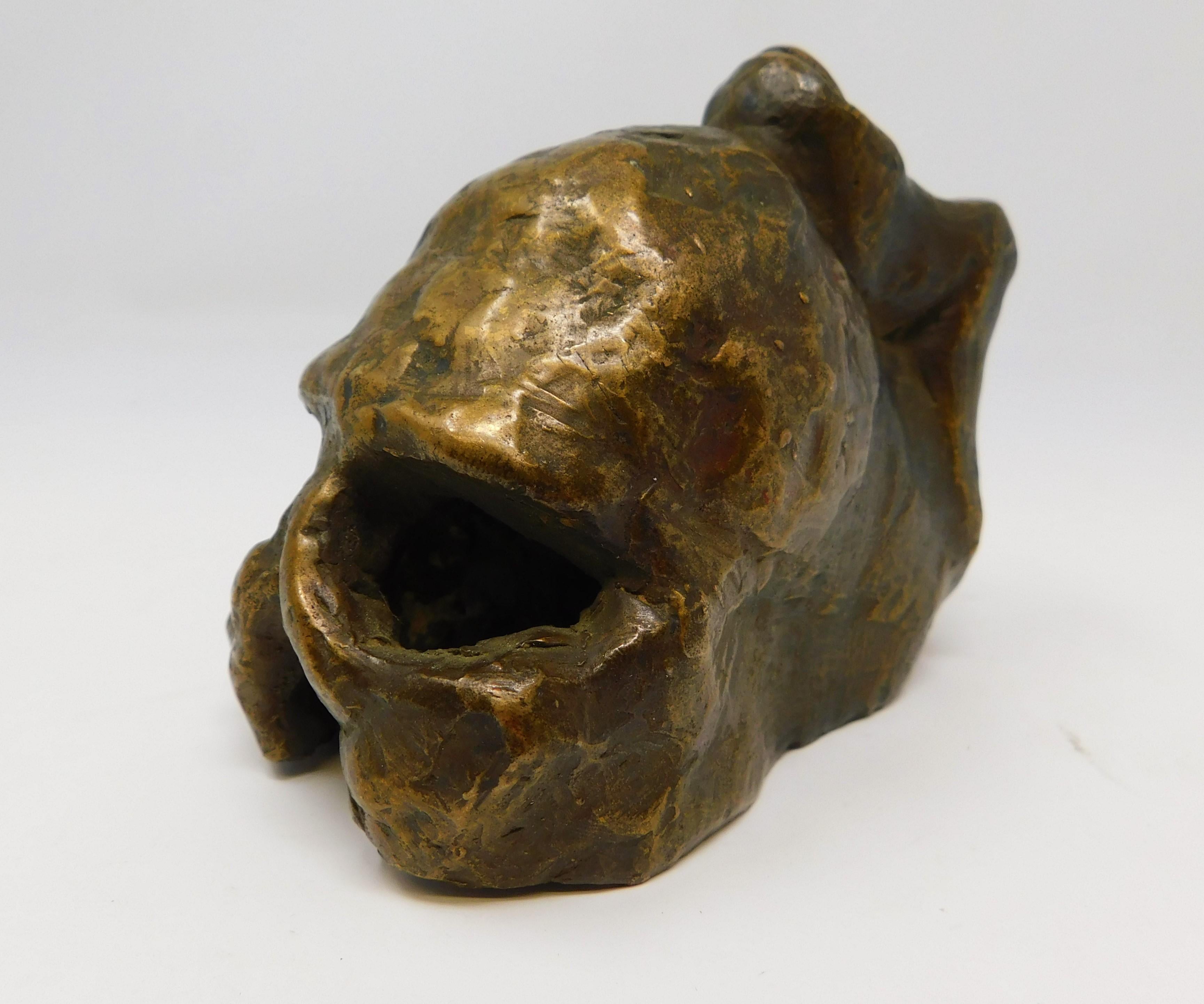 A striking brutalist bronze sculpture of a skull. Incredibly well executed skull with a thumb at the back top of the head. This sculpture was created by a talented and likely well trained hand and is signed WW and is hollow inside.