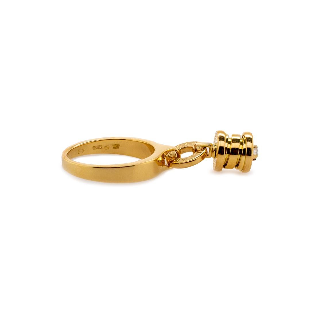 One ladies designer made polished 18K yellow gold, diamond cocktail, charm ring with a tapered, comfort-fit shank. The ring is a size 6 and measures approximately 4.00mm tapering to 2.30mm in width by 8.00mm in diameter and weighs a total of 7.74