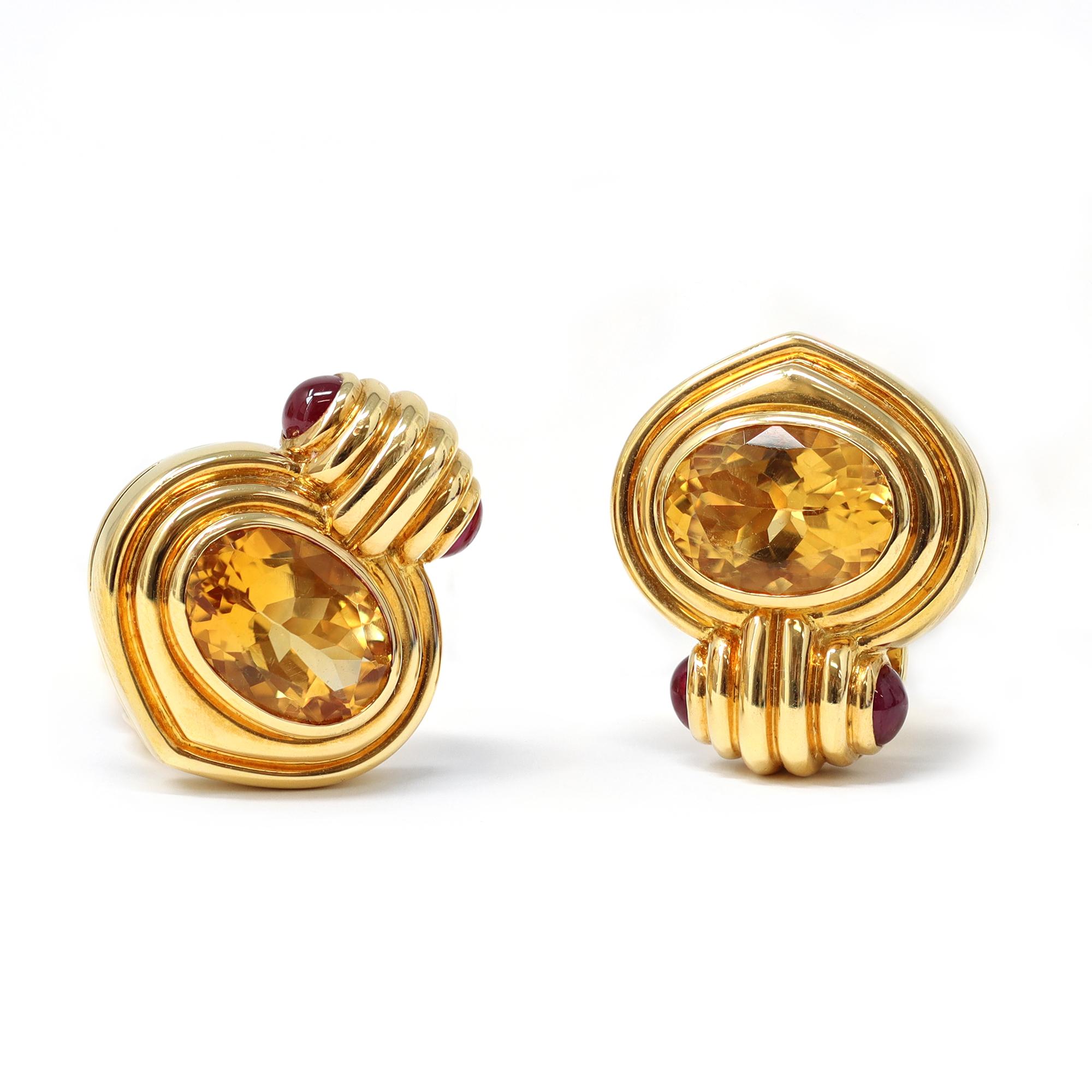 Signed by the iconic Italian house of Jewelry Bvlgari, these lovely clip-on earrings feature perfectly match vivid citrine enhanced with cabochon rubies. The earrings are set in 18-karat yellow gold. They have perfect scale and can be worn on any