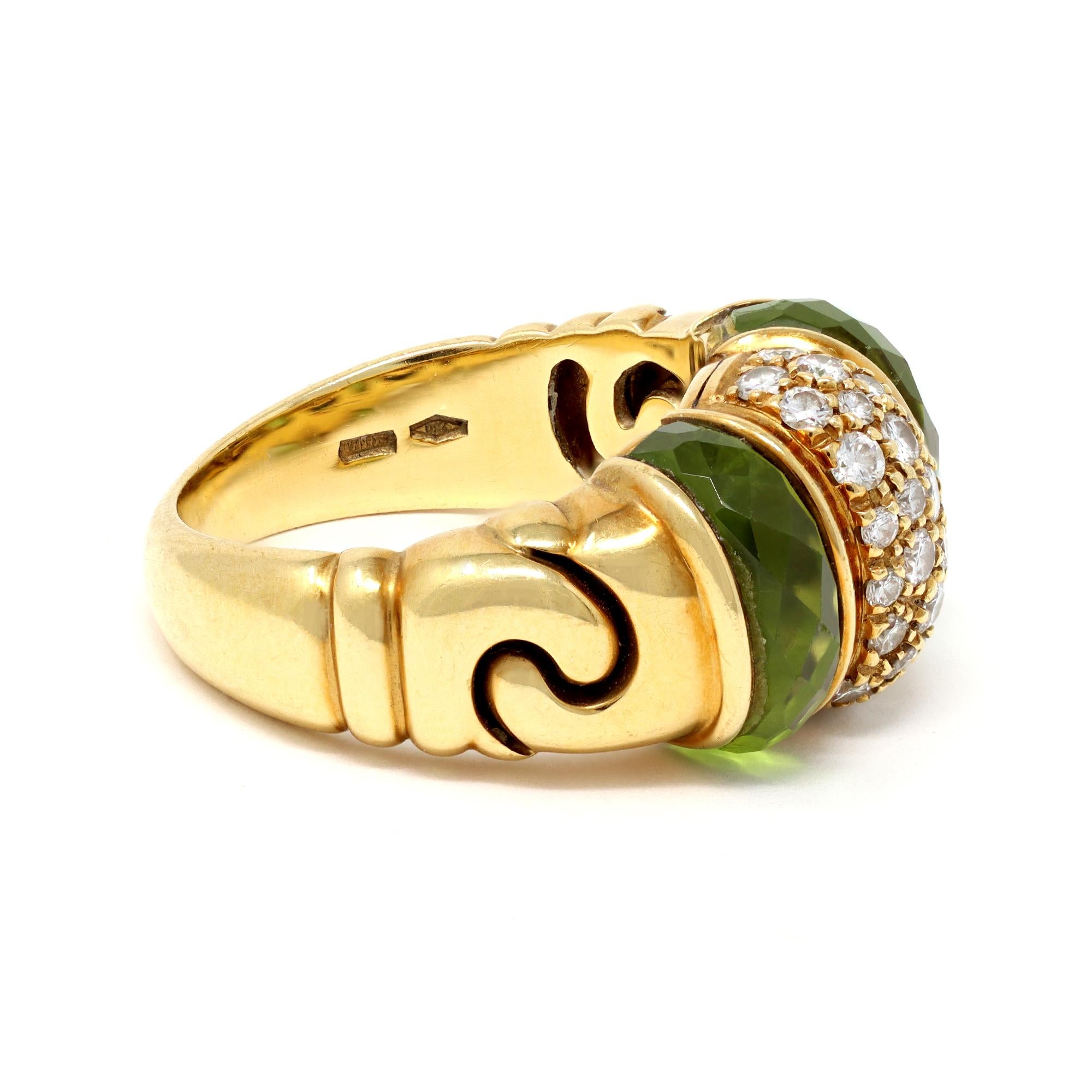 An iconic design from the Italian house of jewelry BVLGARI from the GANCI Collection. The ring features 2 fancy faceted cut peridot separated with a bombé pavé diamond part. The ring is made in 18 karat yellow gold. The estimated diamond weight is