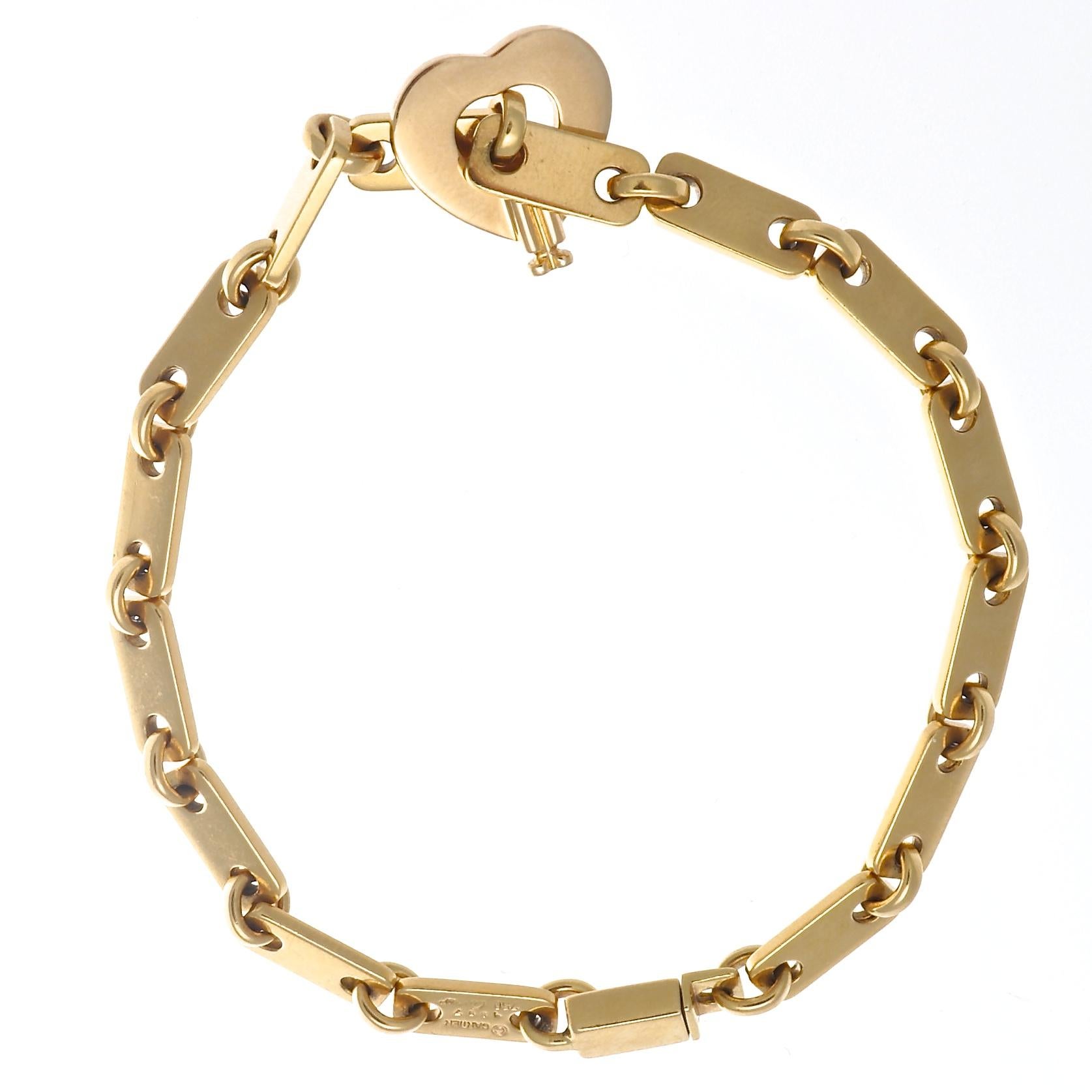 The perfect 18k gold link bracelet with a beautiful open heart clasp, from Cartier France. Circa 1997, and measures 7 1/4 inches long. Signed Cartier and includes serial numbers. Add to your wrist stack or wear it alone, but wear it everyday to keep