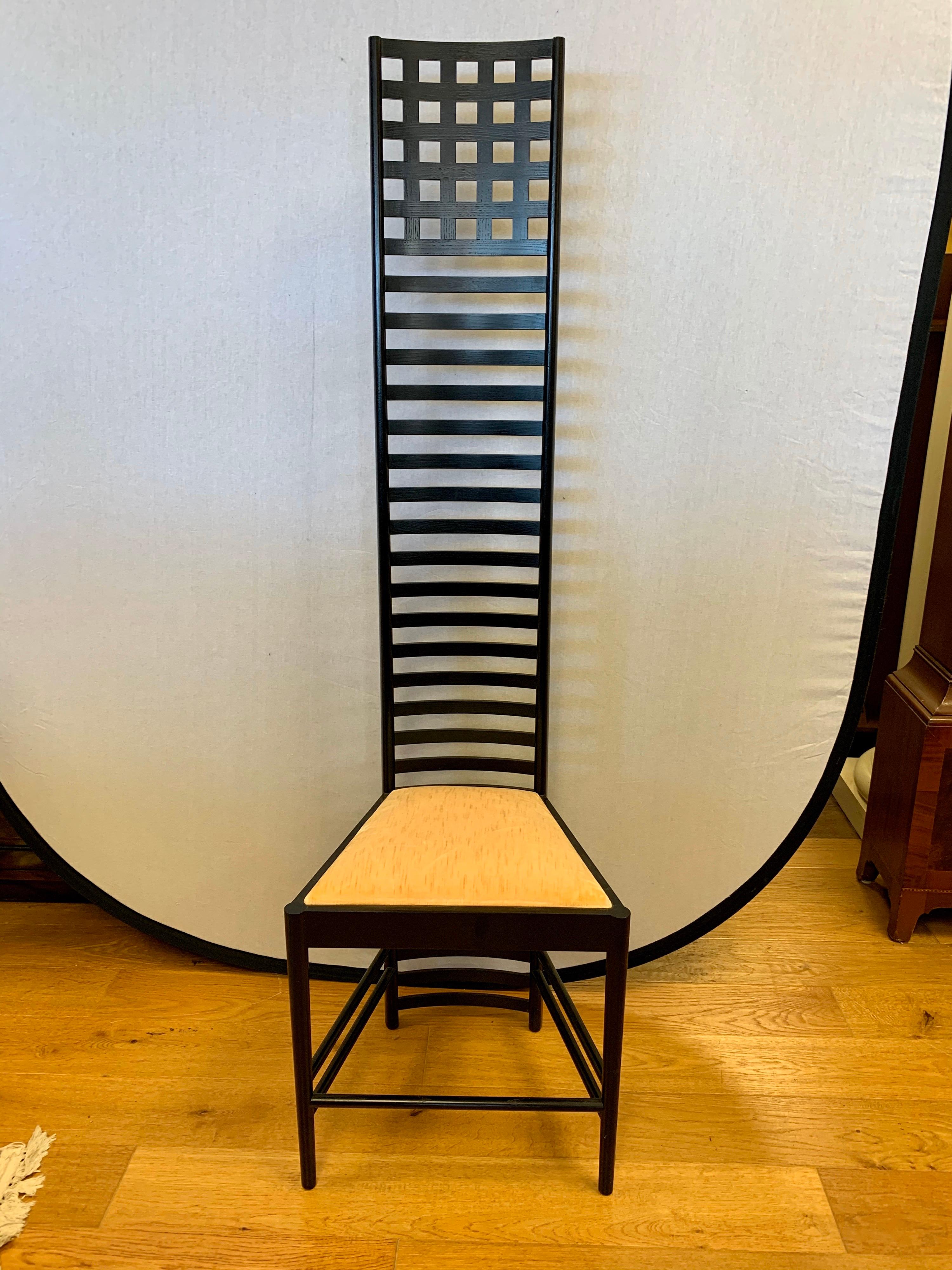 Elegant signed Cassina Charles Rennie Mackintosh Hill House chair. This tall ladder back chair has become a design classic over the years. . The frame is made out of black stained ash wood and the seat cushion is a peach velvet.
All manufacturer