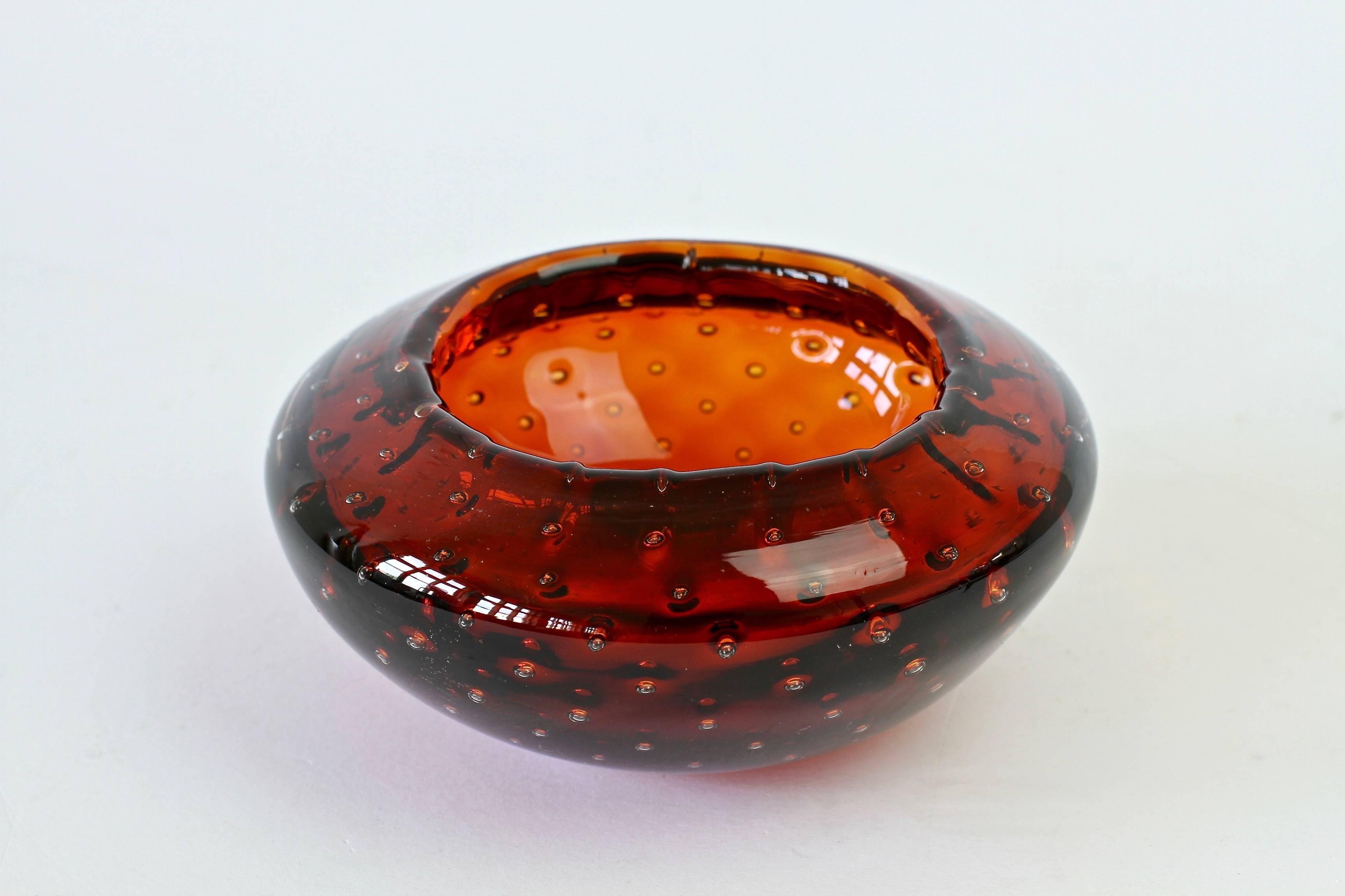 Small petite little round Italian bowl or ashtray by Cenedese. Made from amber colored / coloured Murano glass bullicante or 