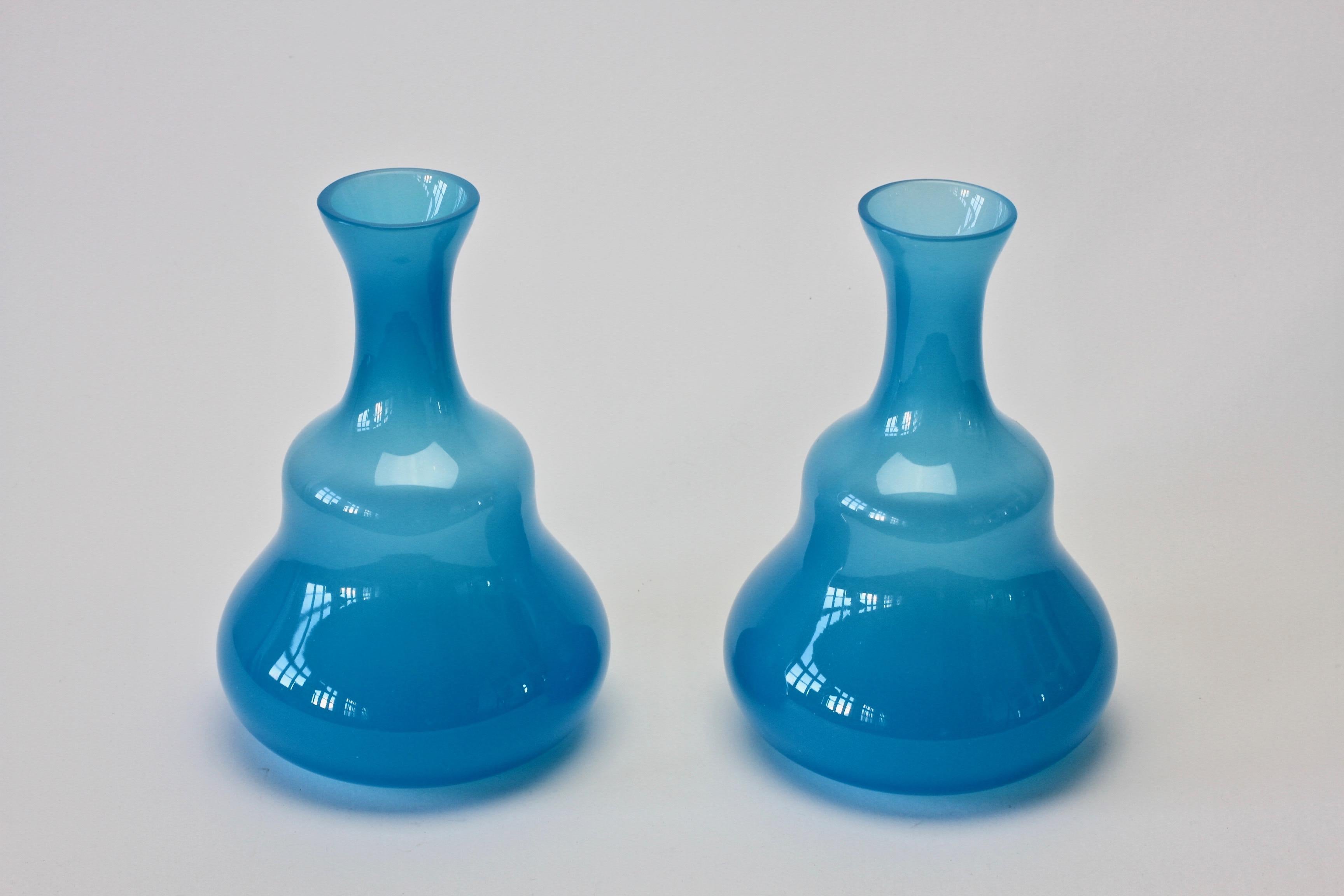 Vintage pair of midcentury funnel necked rippled vases by Cenedese Vetri of Murano, Italy. Elegant form and striking light opaline blue color/colour. 

Dimensions are: 21cm tall, 14.5cm at widest point.

  