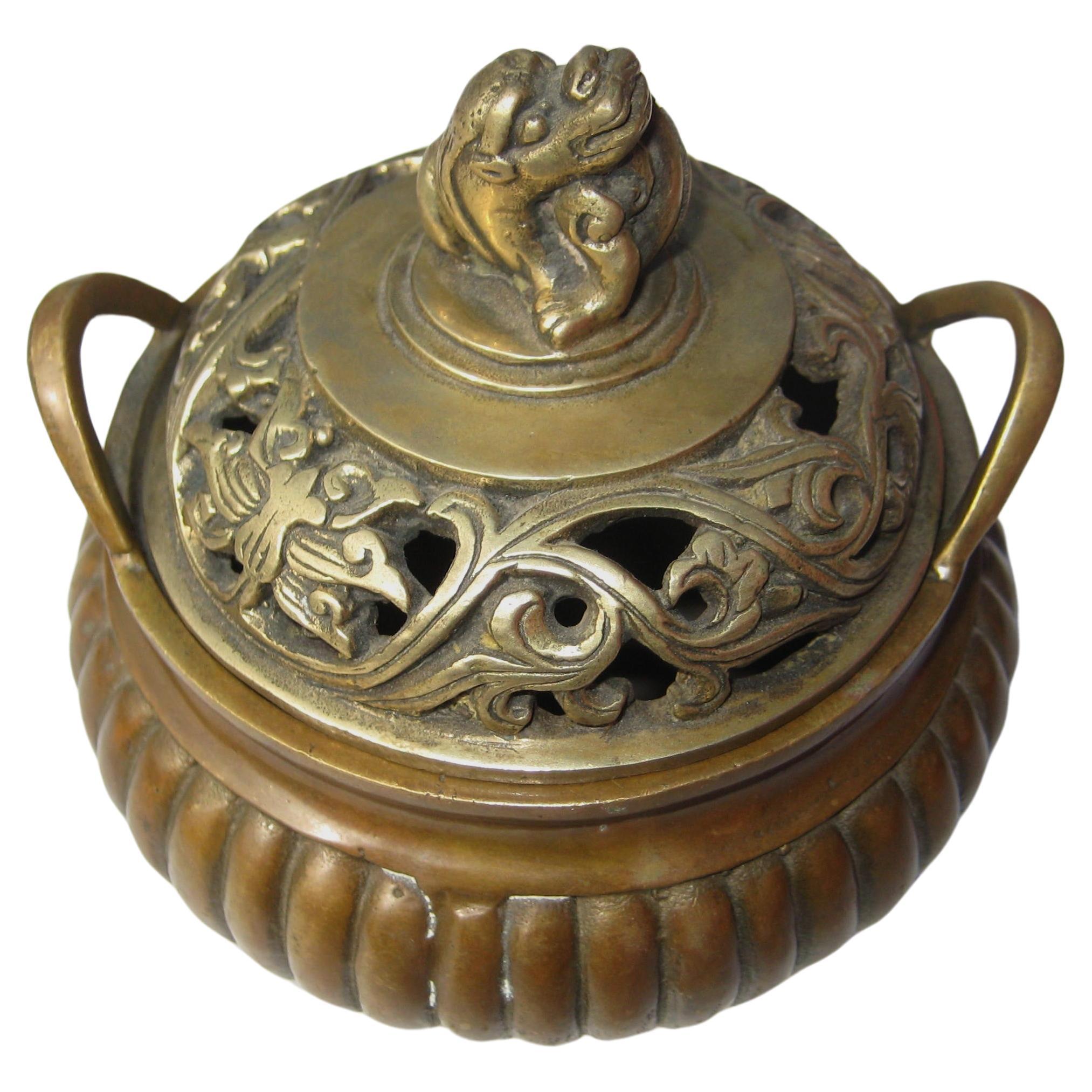 Chinese brass bronze censer. Three footed ribbed bronze bowl w/ two handles. Open work decorated lid w/ raised foo dog at center. Beautiful aged patina to bowl / lid with a more golden color. Signed at bottom of bowl - see pictures. Look at all