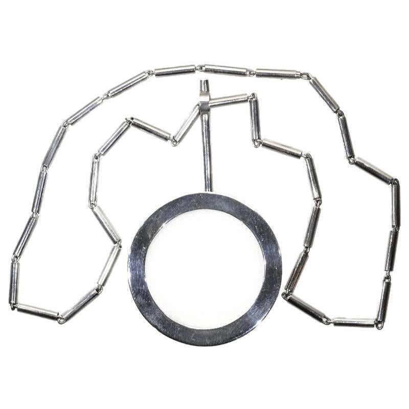 An unique artist necklace c.1969 by Chris Steenbergen in sterling silver, circle pivots around a cylinder, which suspends from its necklace of hinging cannulas. Both necklace and pendant are hallmarked with Dutch control mark representing a standing