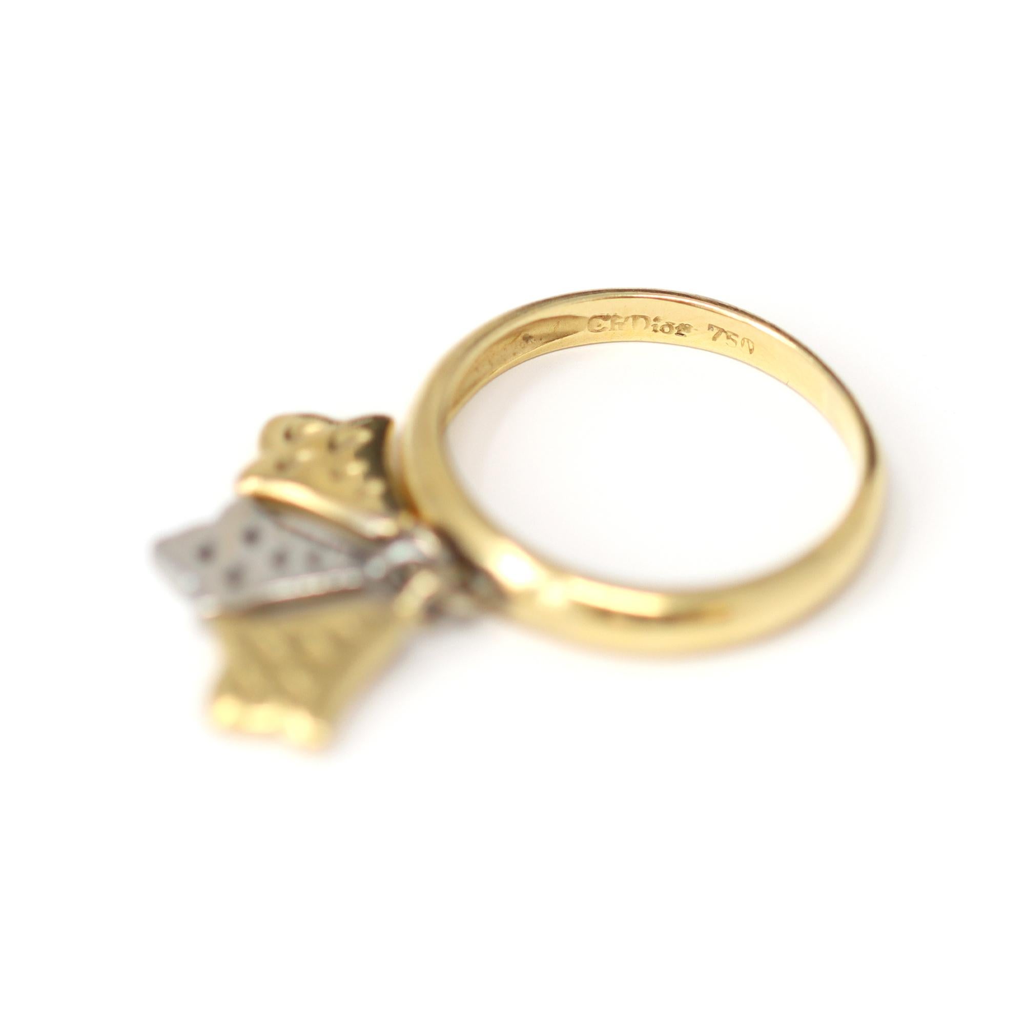 A playful dangling charm ring by the iconic house of Christian Dior. The one-of-a-kind 3-charms ring is made in 18-karat yellow gold, and one of the charms is platinum. It fits a size 6½ and has a gross weight of 5 grams. The ring is signed and