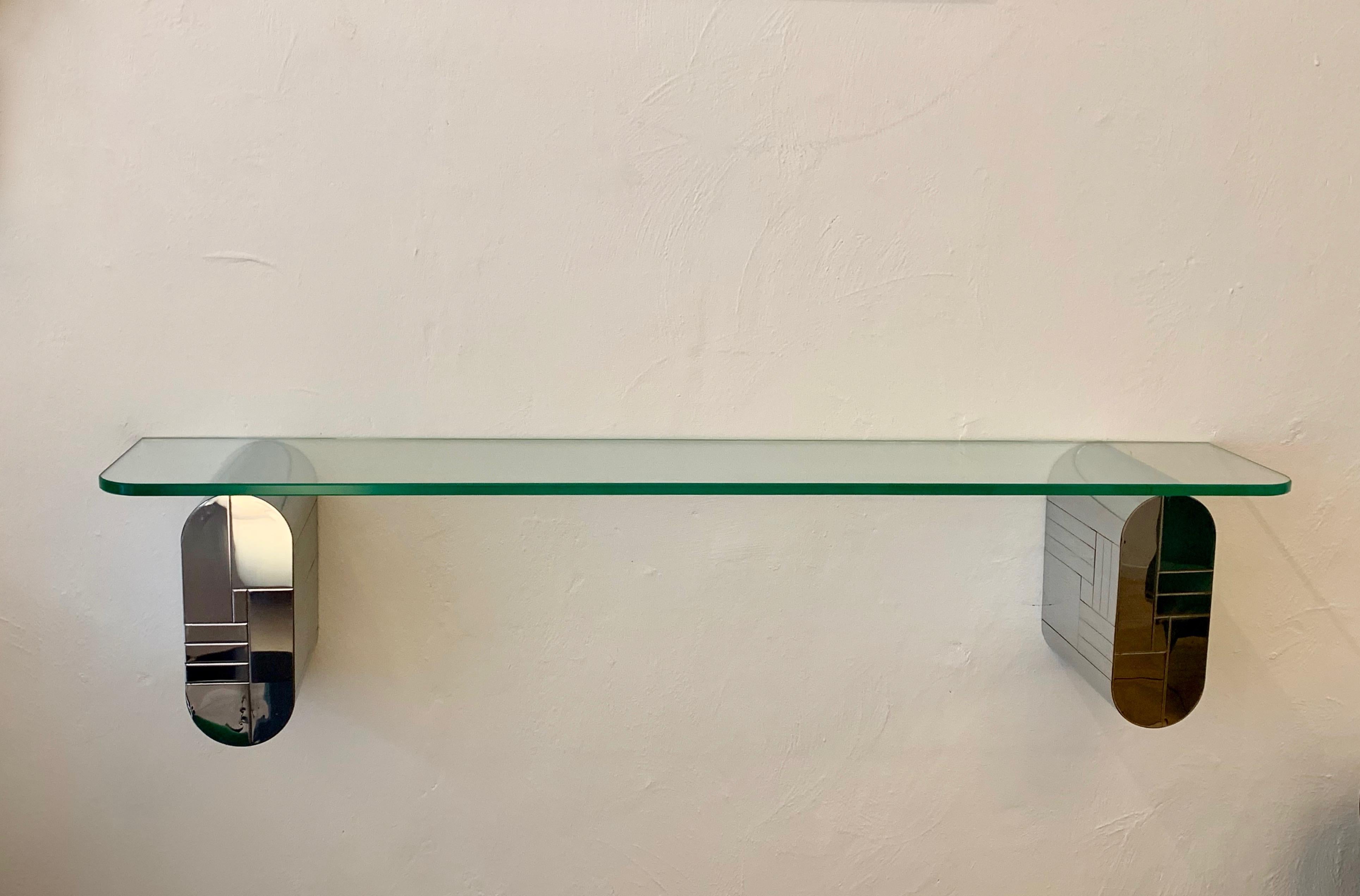 Console from Cityscape series by Paul Evans for Directional Furniture. Consisting of two chromed panelled wall-mounted brackets with a floating glass top.  
Signed, Paul Evans signature present (see photo's). 

Wall brackets are mounted on wall by a
