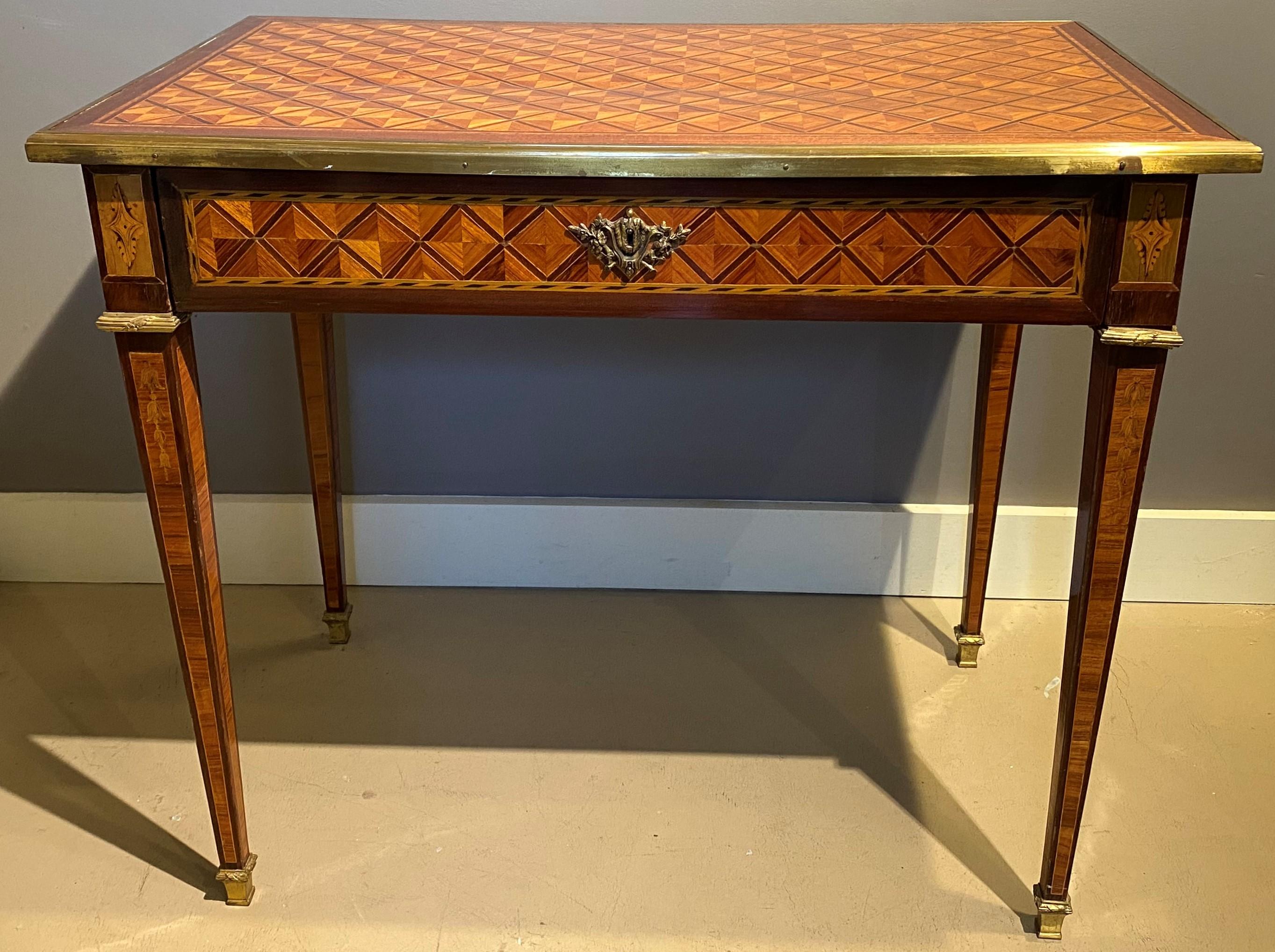 An exceptional 19th century rectangular fruitwood metamorphic or mechanical table / writing desk with sliding brass bound top, brass ormolu, and a single drawer, opening to reveal an adjustable leather top writing surface with gilt scrollwork