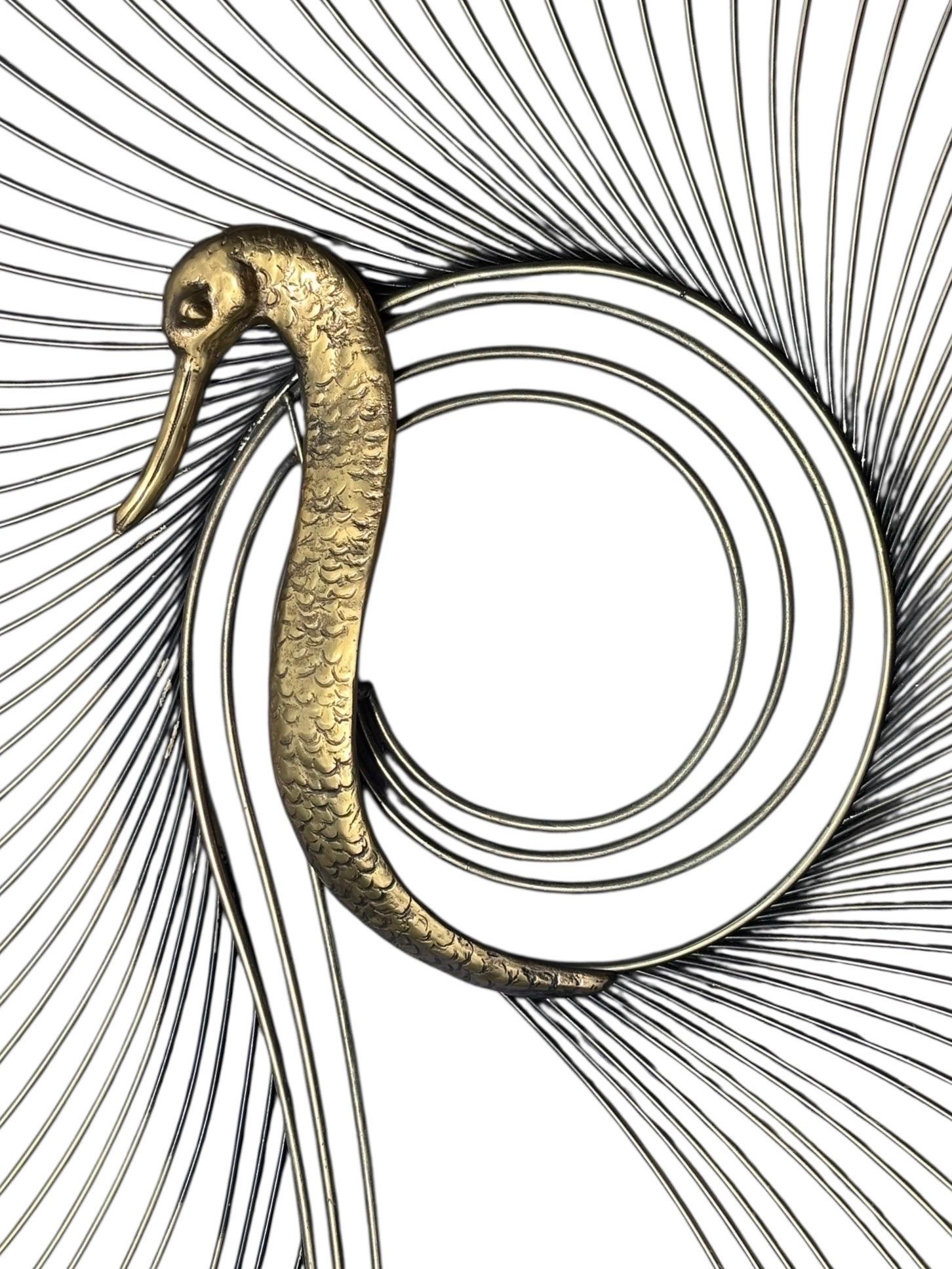 A large contemporary brass wall sculpture of a swan by Curtis Jere. Curved brass rods fan out to form a circular shape around a brass birds head. Signed and dated 1987 at the base.