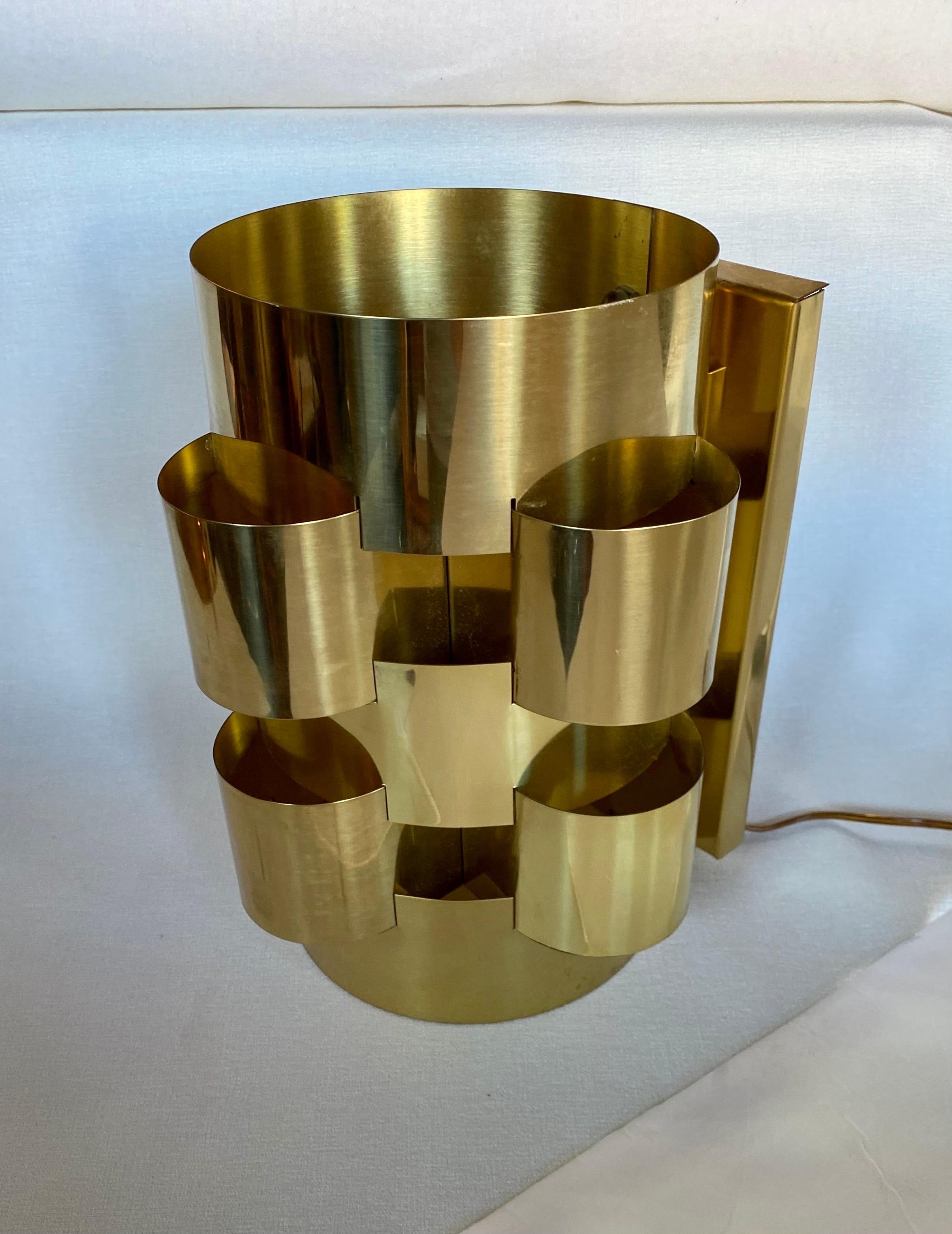 Fabulous, lacquered brass cloud wall sconce light fixture by Curtis Jere. This sculptural postmodern wall lamp features a reflective city scape style polished brass finish. A truly unique design, brutalist cityscape style. 

Signed and dated 