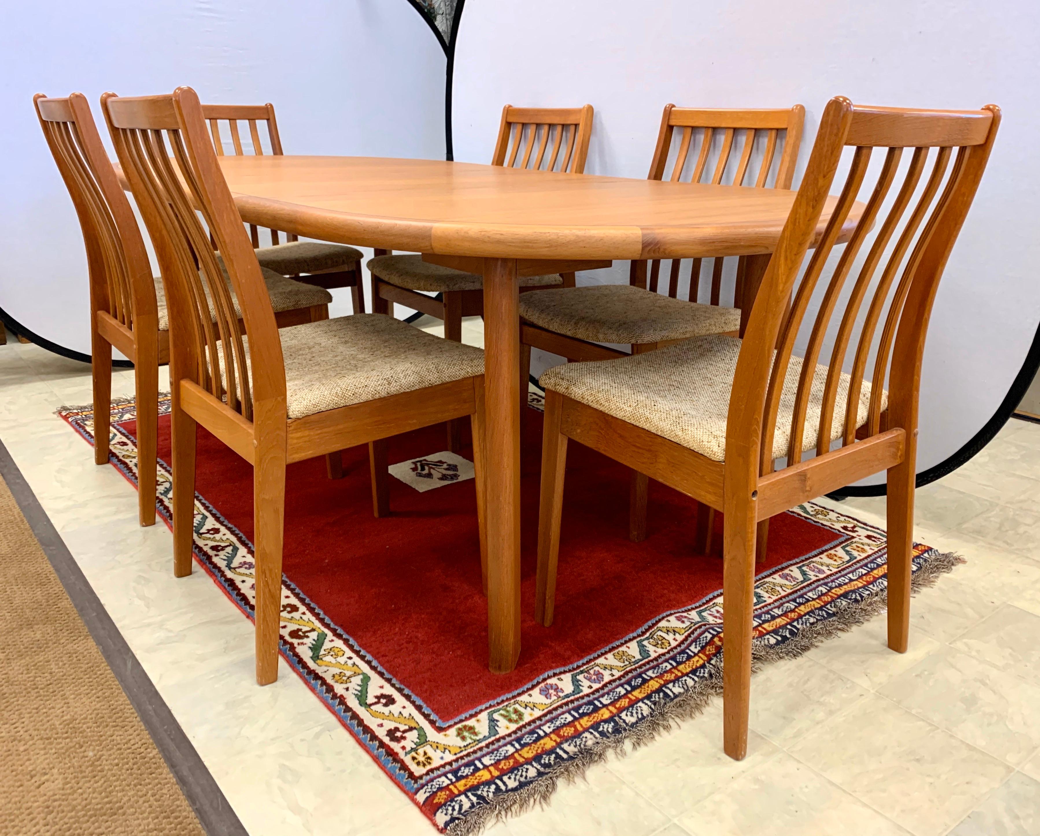 A coveted Danish modern signed dining room set from Denmark's Vamdrup and Stolefabrik.
It is in mint condition and consists of a teak dining table with one leaf and six matching chairs all
with original fabric. The dimensions of the table are
