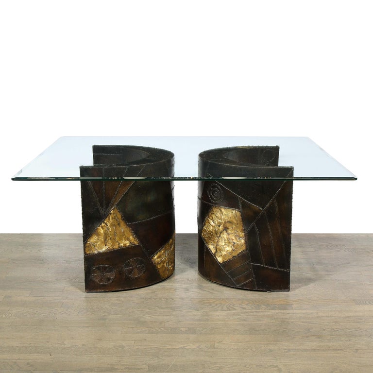 This Iconic glass topped dining table by the master Paul Evans for directional features two pedestal arc form bases of welded bronze and steel with polychrome detailing and patchwork design. It is signed P E 70 .This table come with the original