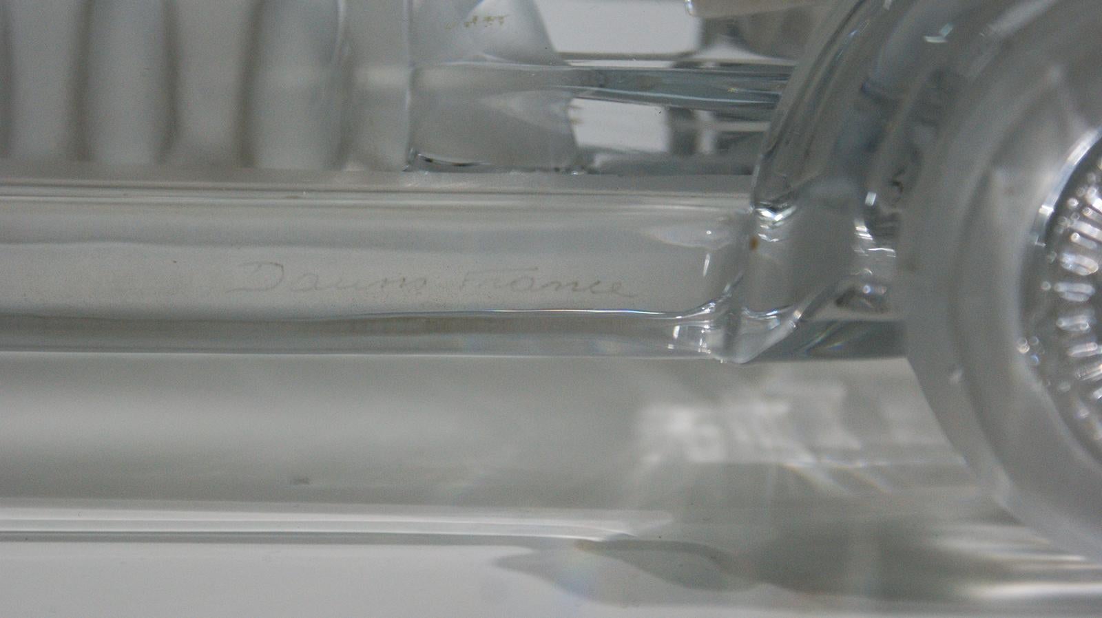 Rare crystal sculpture of a vintage sport racing car signed by Daum France, in 1970s.
Crystal with frosted details, and number 7 engraved.
Marked Daum France at the bottom of the sculpture.


   