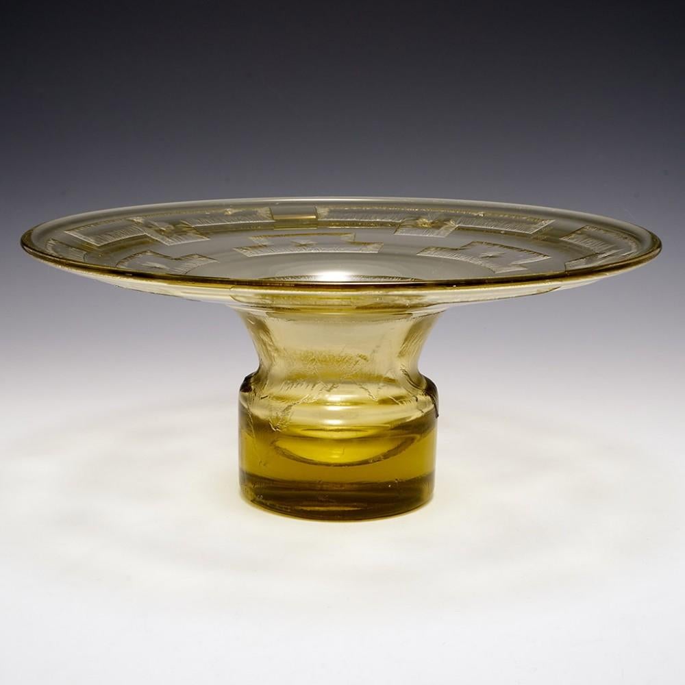 A Daum Nancy pale yellow glass coupe from c1930. The very height of Art Deco elegance the bowl us undercut with an exploded tessellating geometric  design and stylised leaves.  It is signed DAUM☨NANCY France to side of foot

When Jean Daum assumed