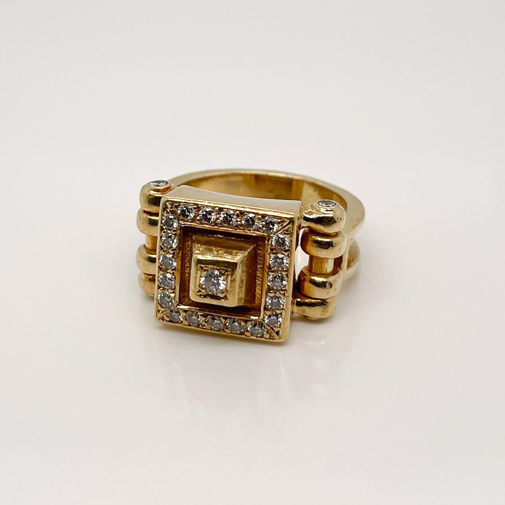 A very fine signed designer 18k gold and diamond signet style ring.

In the Art Deco style with a stylized Pyramid shaped head and pave set throughout with round brilliant cut white diamonds.

Illegiblely marked and likely Swiss or German.

Simply a