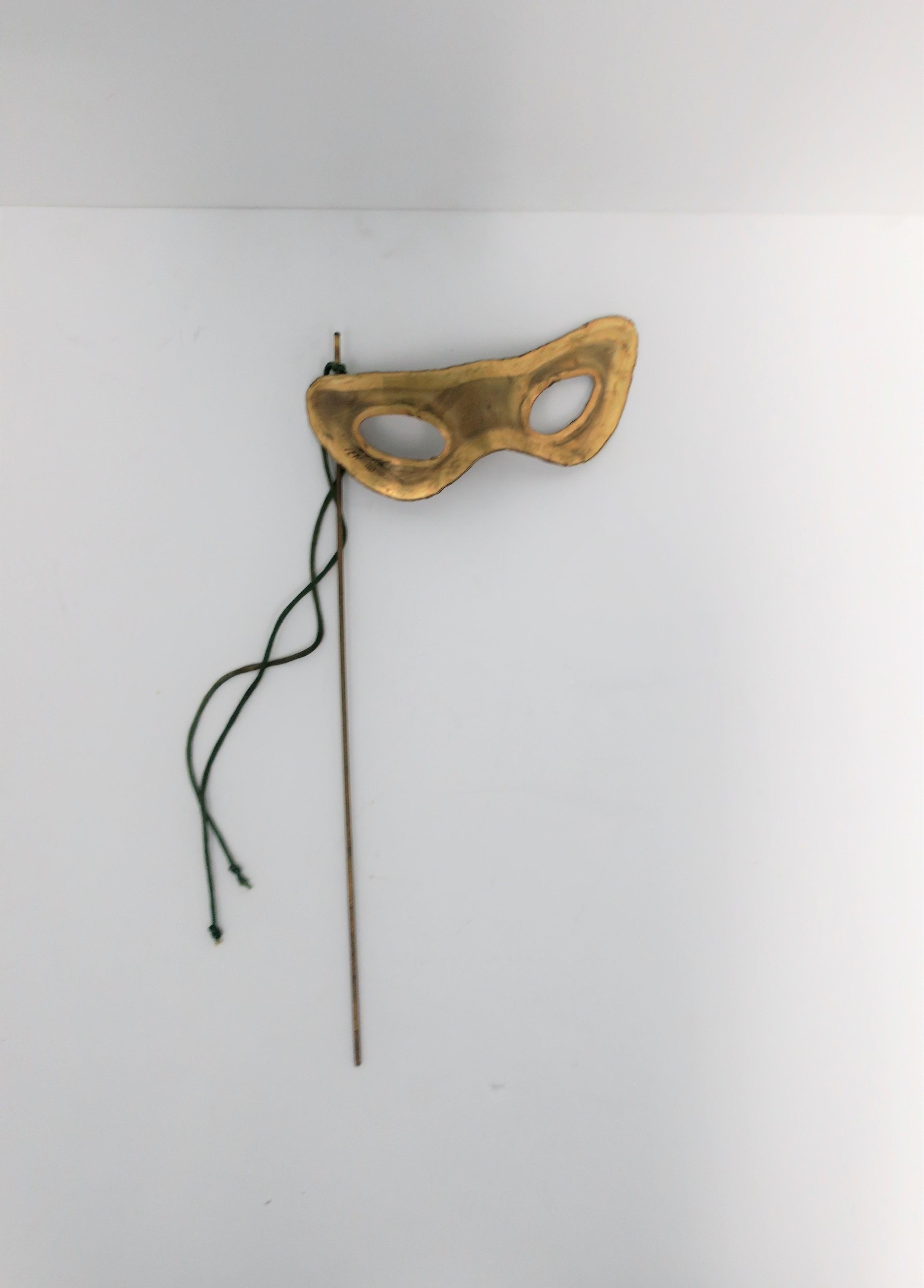 A unique late 20th century hand-held signed and dated designer brass Masquerade mask, circa 1990s. Signed 