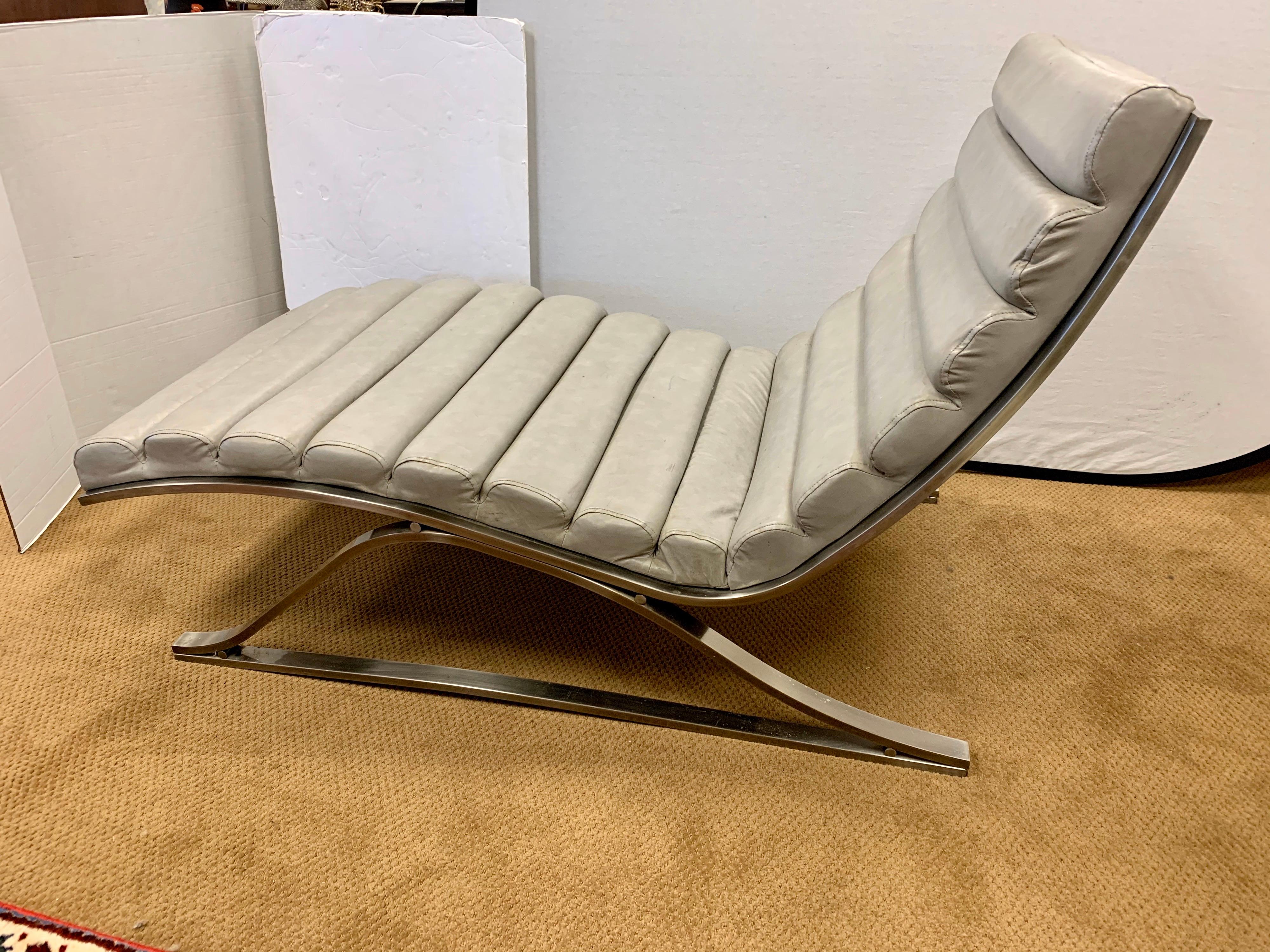 Classic chaise lounge chair made of heavy steel and soft gray leather. It is signed
by DIA the Design Institute of America and is a true period piece. The chrome is in great shape but the
leather has some staining that looks like ink spots in a