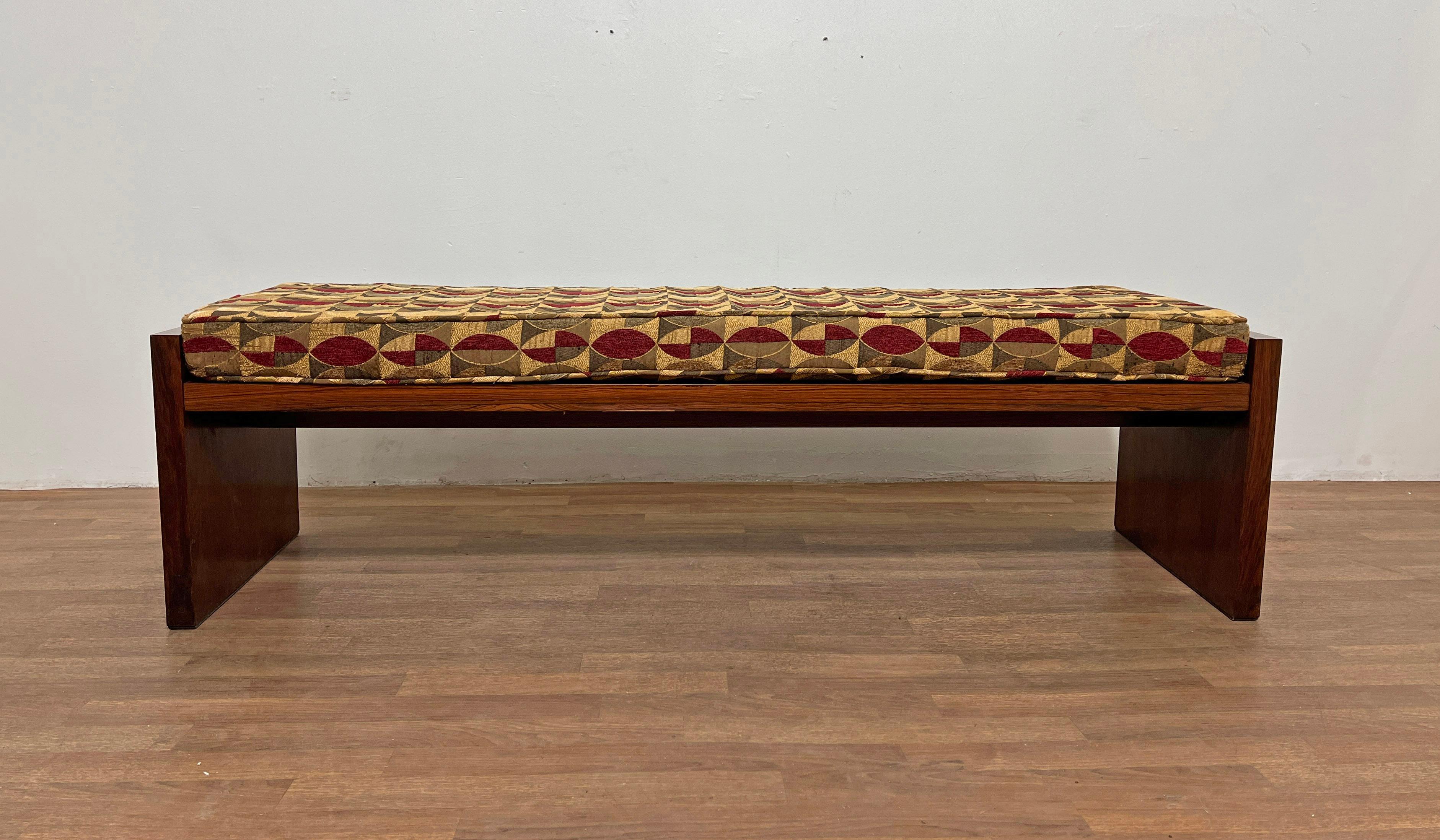 A rosewood bench by Dunbar, ca. 1960, with original seat cushion and what appears to be a Jack Lenor Larsen jacquard fabric.  This all-wood version of Dunbar's bench is most often attributed to Ed Wormley, while a similar design with chrome or