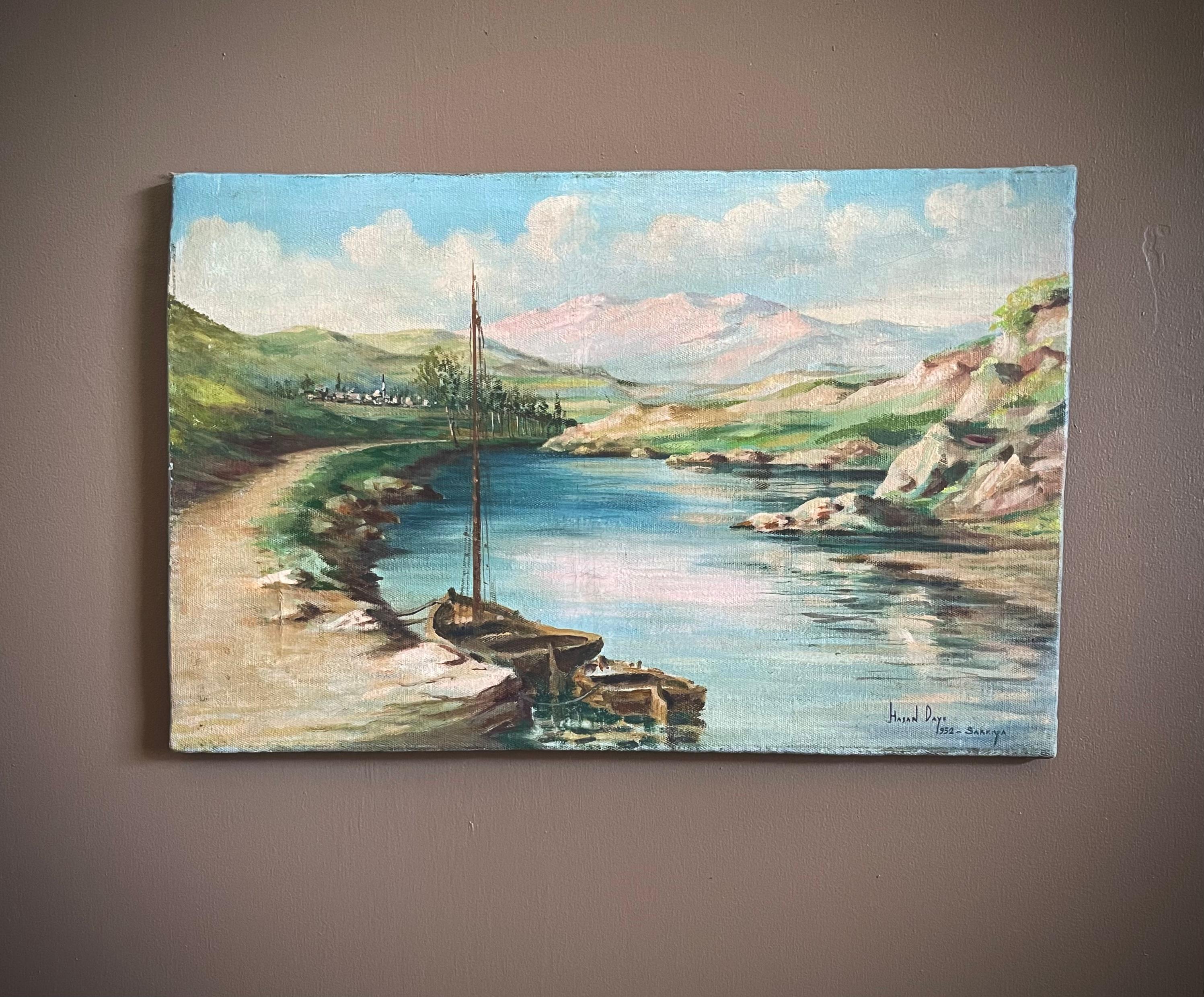 Step into the past with this enchanting 1952 Dutch oil painting capturing the serenity of a sailboat with its attached dingy gracefully navigating through a tranquil sound, framed by majestic mountains in the background. The artist's meticulous