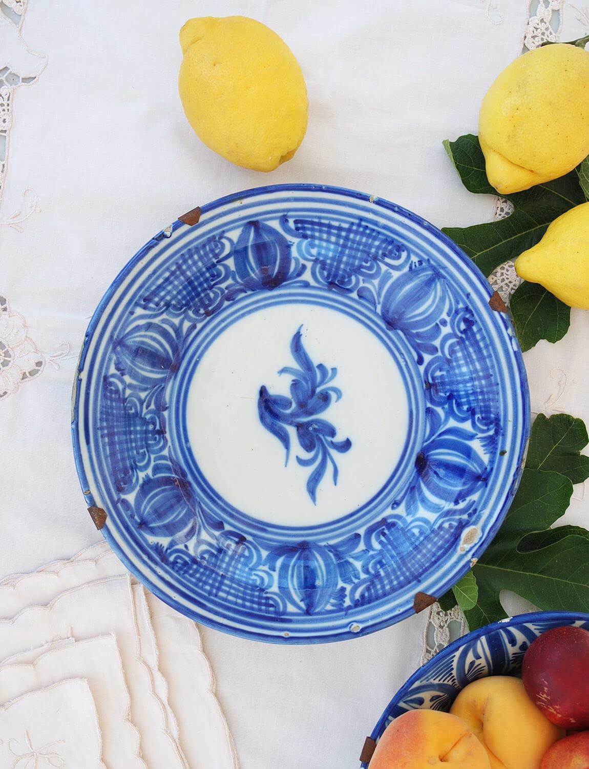 This beautiful sicilian plate was made in the early 1800s. It has been hand painted and hand-glazed with a wonderful flower and pattern surround. The initials R.G of the artist who made it have been painted on the side. This plate was found in a