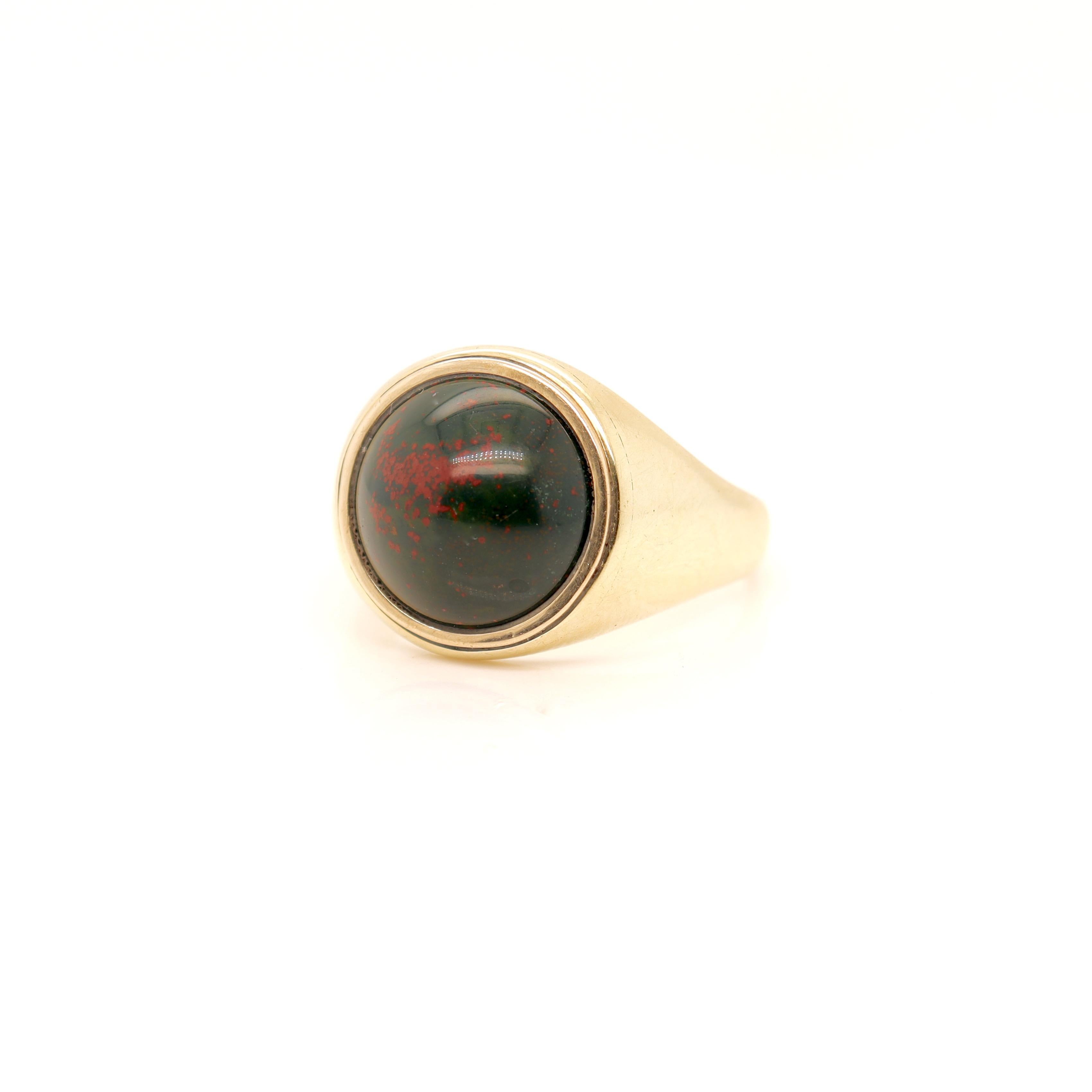 A fine Edwardian gold & bloodstone cabochon ring.

In 14K gold.

By Marcus & Co.

Set with a fine bloodstone cabochon. 

The stone is high set in its bezel and the ring's shoulders and sides taper to a thin shank at the back.

Marked with an etched