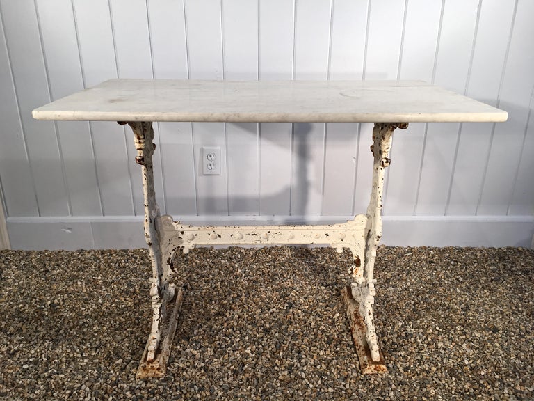 This lovely cast iron table base is from Birmingham and is signed on the feet by its maker, Gaskill and Chambers. Its original grey marble top was broken in shipment, so we have paired it with a late 19th century white marble top with three finished