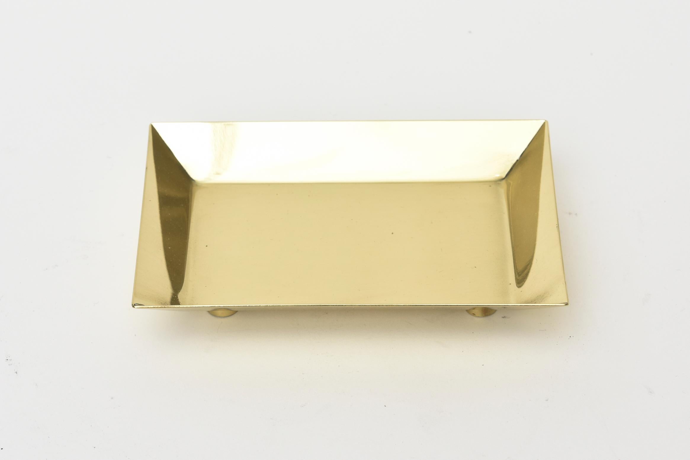 This architectural Mid-Century Modern polished brass footed small bowl and or small desk tray is signed by a German designer and architect named Ernst Lichtblau. It has small brass round feet. It is from the 1950s. Great for a desk accessory for a