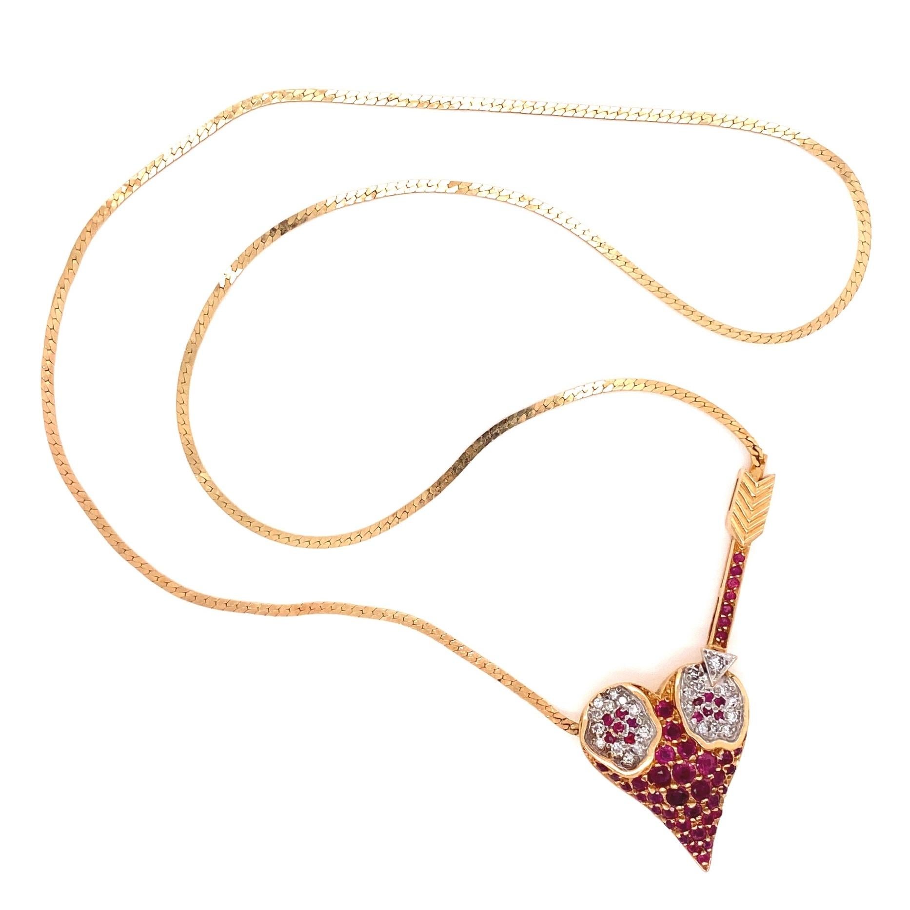 Beautiful and Striking ERTE Signed Designer Pendant Necklace featuring an Arrow and Heart, encrusted with 22 round diamonds weighing approx. 0.23 total carat weight and 53 rubies, approx 2.50 total carat weight. Necklace measures approx. 18