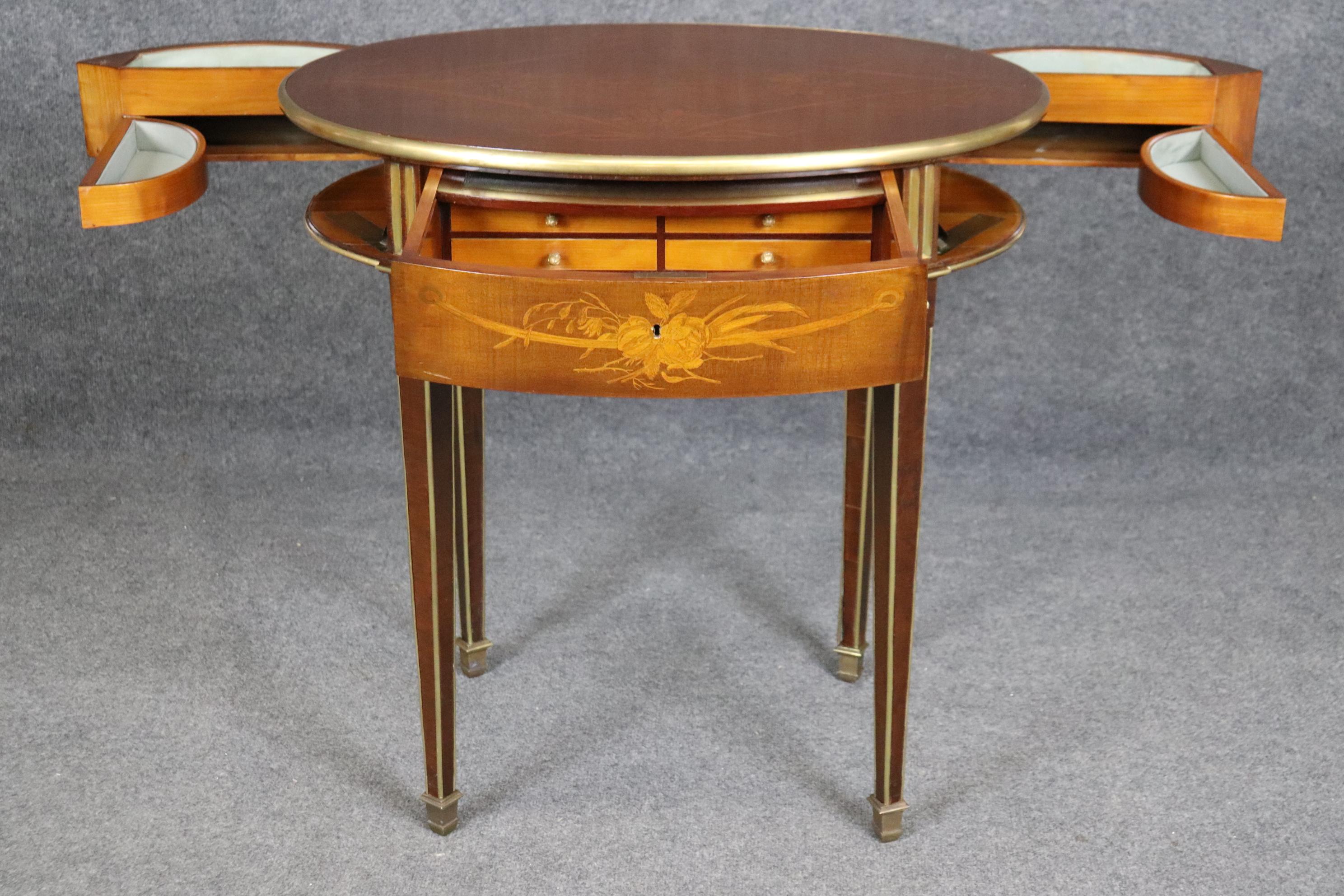 This is an incredible signed L Escalier De Cristal of Paris metamorphic desk or ladies vanity. The desk is beautifully inlaid and features inlaid brass inside the fluted legs and a gorgeous original finish. The piece dates to the 1880-90s era and is