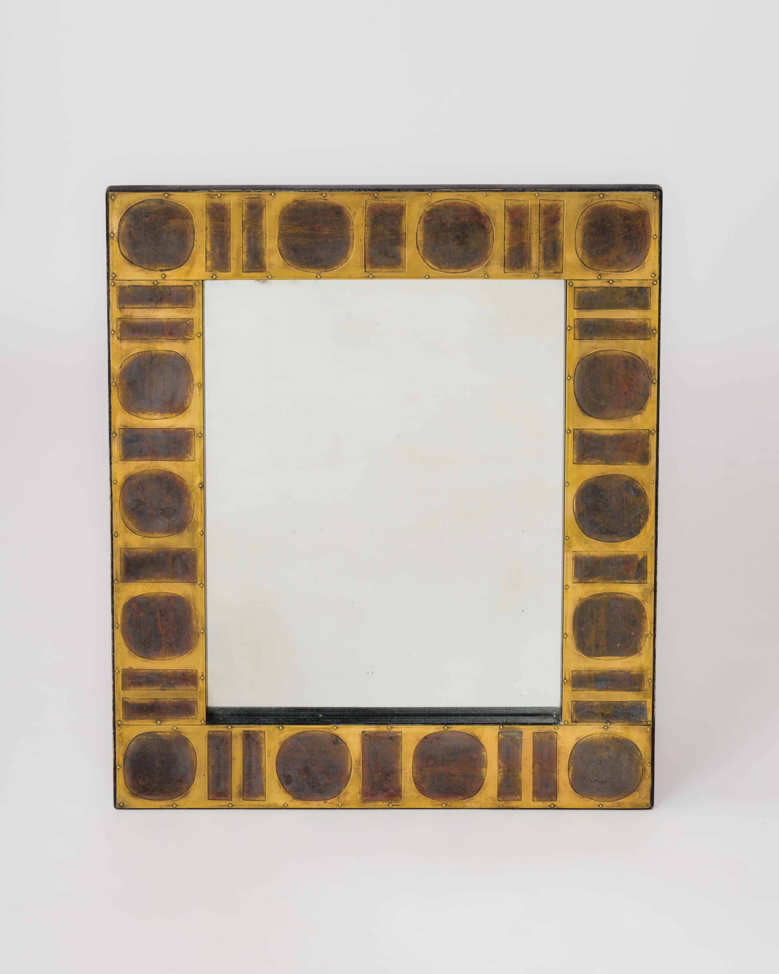 Unique wall mirror by Jean Blazy, France 1970's. Signature present on top of bottom right corner tile.
Made of cut brass tiles over a wooden frame.  Each tile is etched and oxydated in singular pattern. High decorative impact for this must have