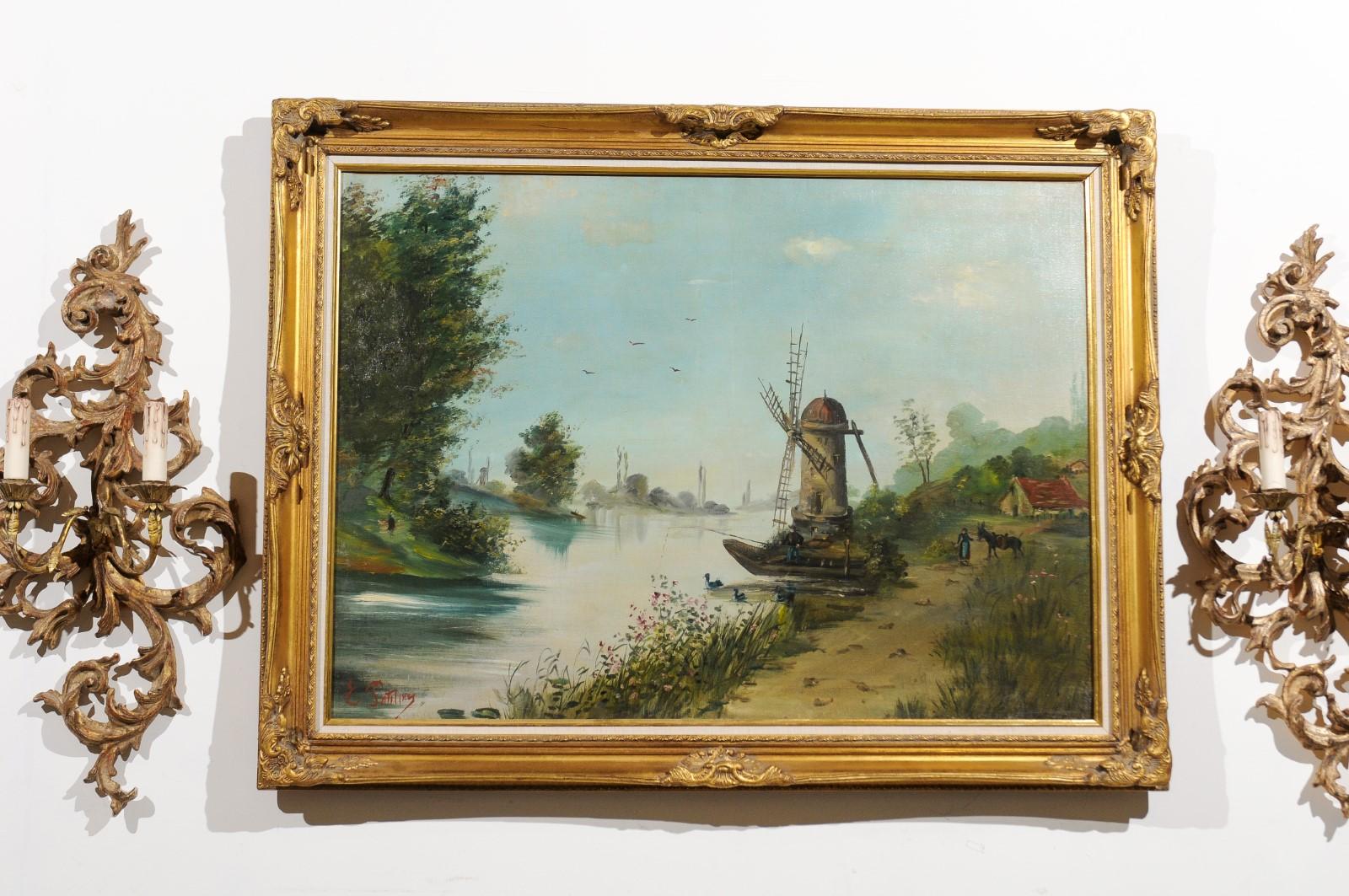 A French oil on canvas landscape painting from the early 20th century with giltwood frame, signed Eugène Petitpas. Born in France during the early years of the 20th century, this charming oil on canvas painting features a palette made of blue, green
