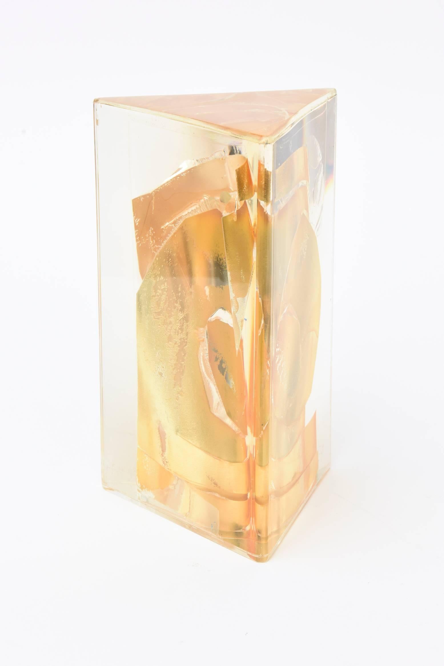 This fabulous Lucite vintage embedded sculpture is signed Béjar 1971 on the bottom. It has fragments of fractal solid gold leaf embedded and encased in the Lucite triangular form. It is much more rich and beautiful in person. The outside of the