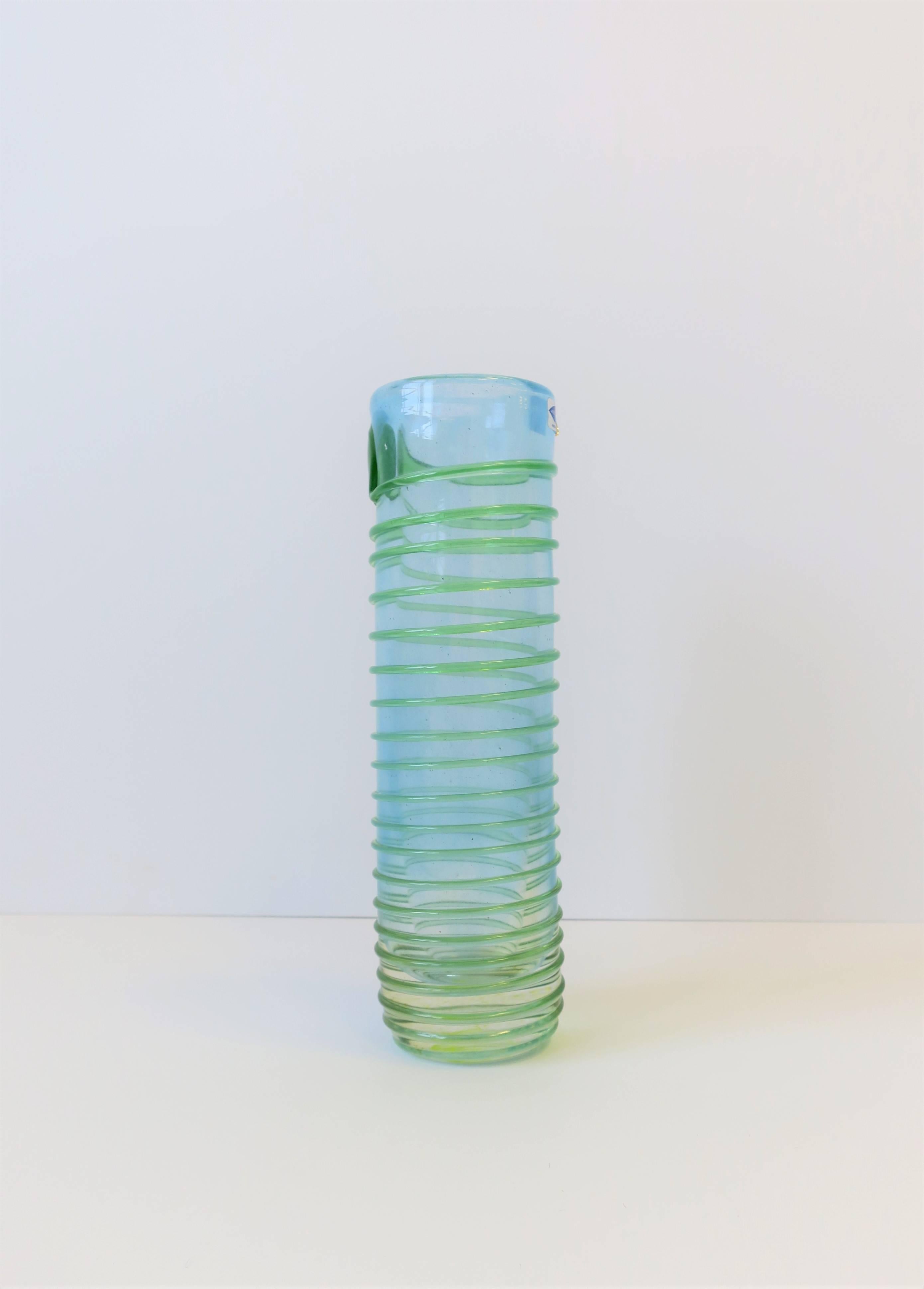 A beautiful signed Finnish art glass vase, circa 20th century, Finland. Piece is signed on bottom as show in image #14. Marker's mark label, image #15. Art glass colors include a translucence light blue wrapped with an emerald green art glass.